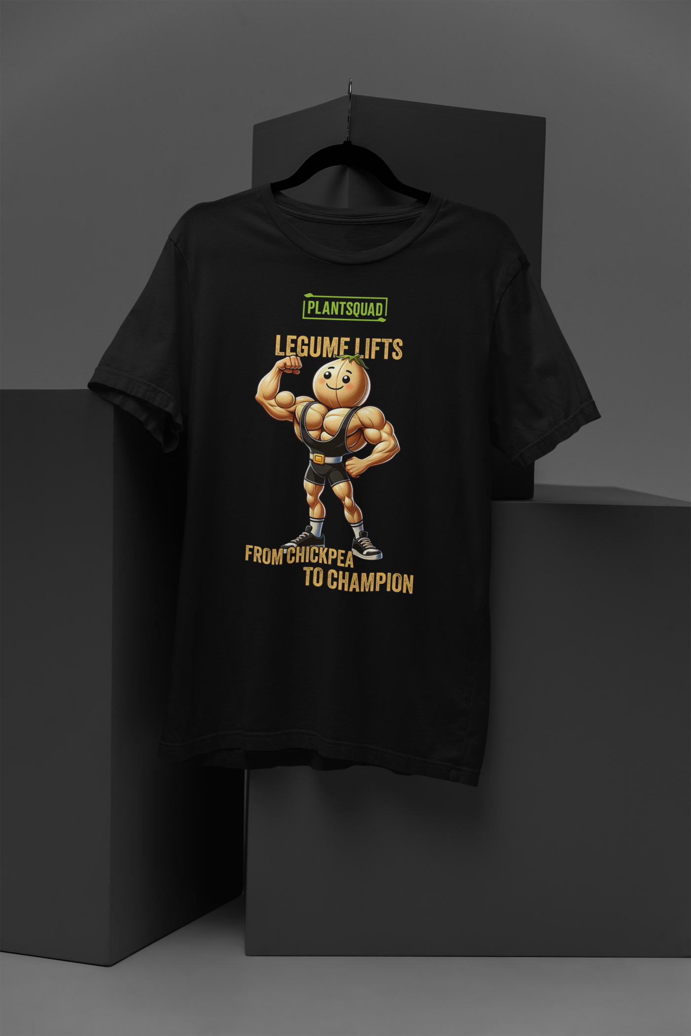 A black T-shirt featuring a muscular, anthropomorphic chickpea in a black singlet. The text reads, "PLANTSQUAD LEGUME LIFTS FROM CHICKPEA TO CHAMPION." The chickpea is flexing its biceps and smiling confidently. This is the Plantsquad Chickpea "Legume Lifts" - Unisex T-Shirt.