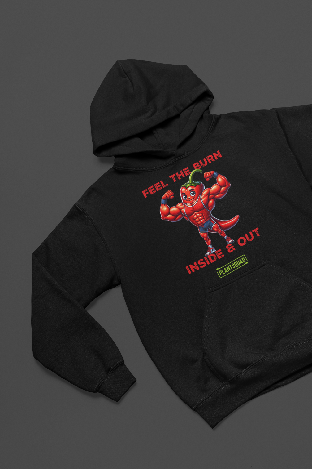 The Plantsquad Chilli "Feel The Burn Inside & Out" - Unisex Hoodie is a black weight lifting hoodie with a design of a muscular cartoon chili pepper flexing its muscles. The text above reads "Feel the Burn" and below it reads "Inside & Out." The bottom text features the logo "PlantSquad" in green and white, perfect for showcasing your plant-based, vegan lifestyle.