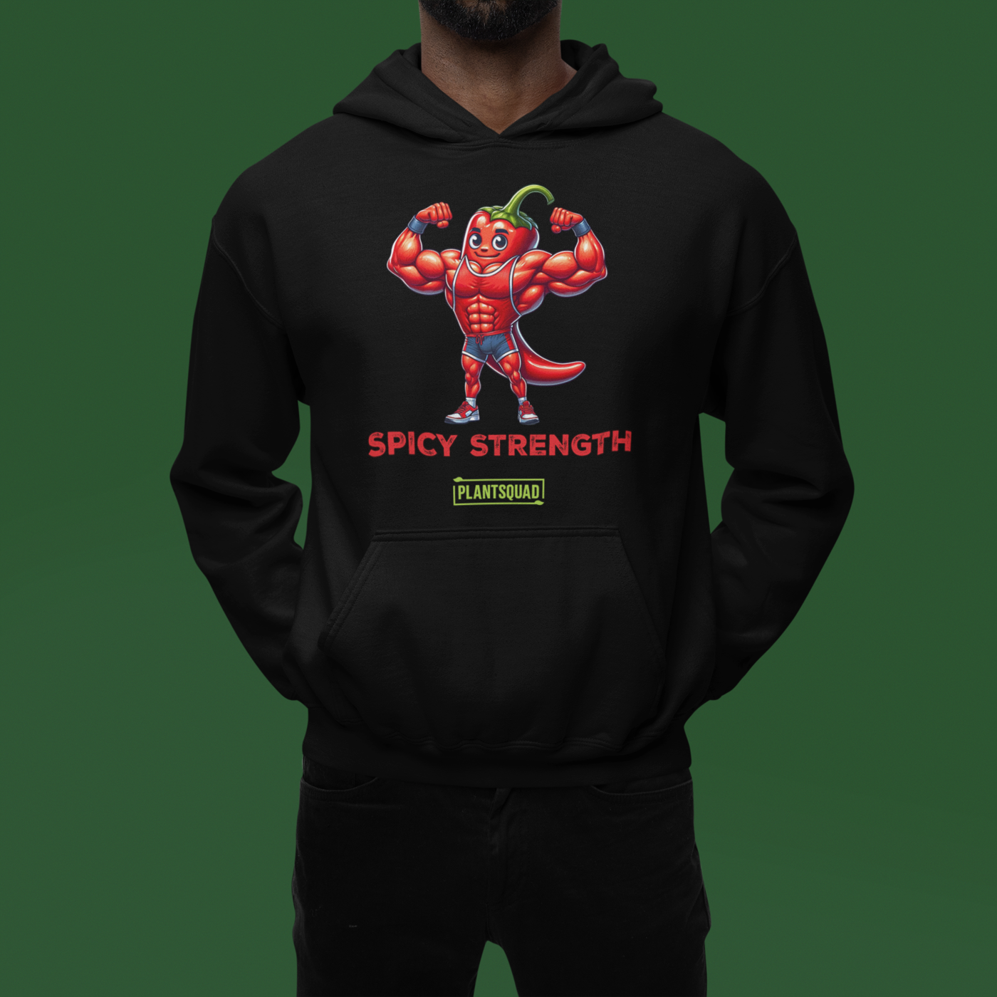 The Plantsquad Chilli "Spicy Strength" - Unisex Hoodie features a cartoon muscular chili pepper character flexing its biceps. The text "SPICY STRENGTH" is written below in red, bold letters. Lower on the hoodie, there is a green rectangular label with the text "PLANTSQUAD" in white, perfect for anyone embracing the vegan lifestyle.