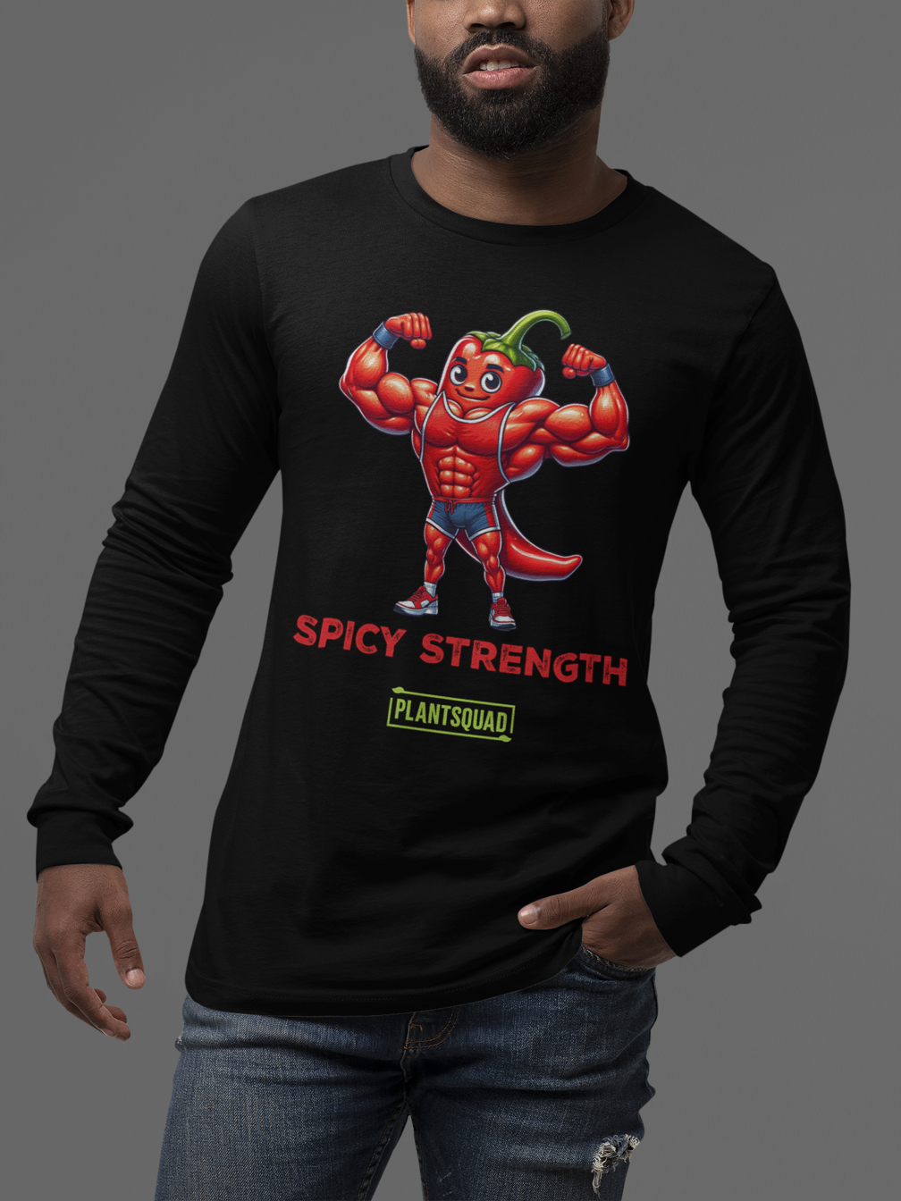 A Plantsquad Chilli "Spicy Strength" - Unisex Long Sleeve T-Shirt displaying a muscly chili cartoon character with muscles, flexing its arms. Below the character, the text reads "SPICY STRENGTH" and "PLANTSQUAD" in red and green fonts, respectively—perfect for fitness enthusiasts embracing a vegan lifestyle.