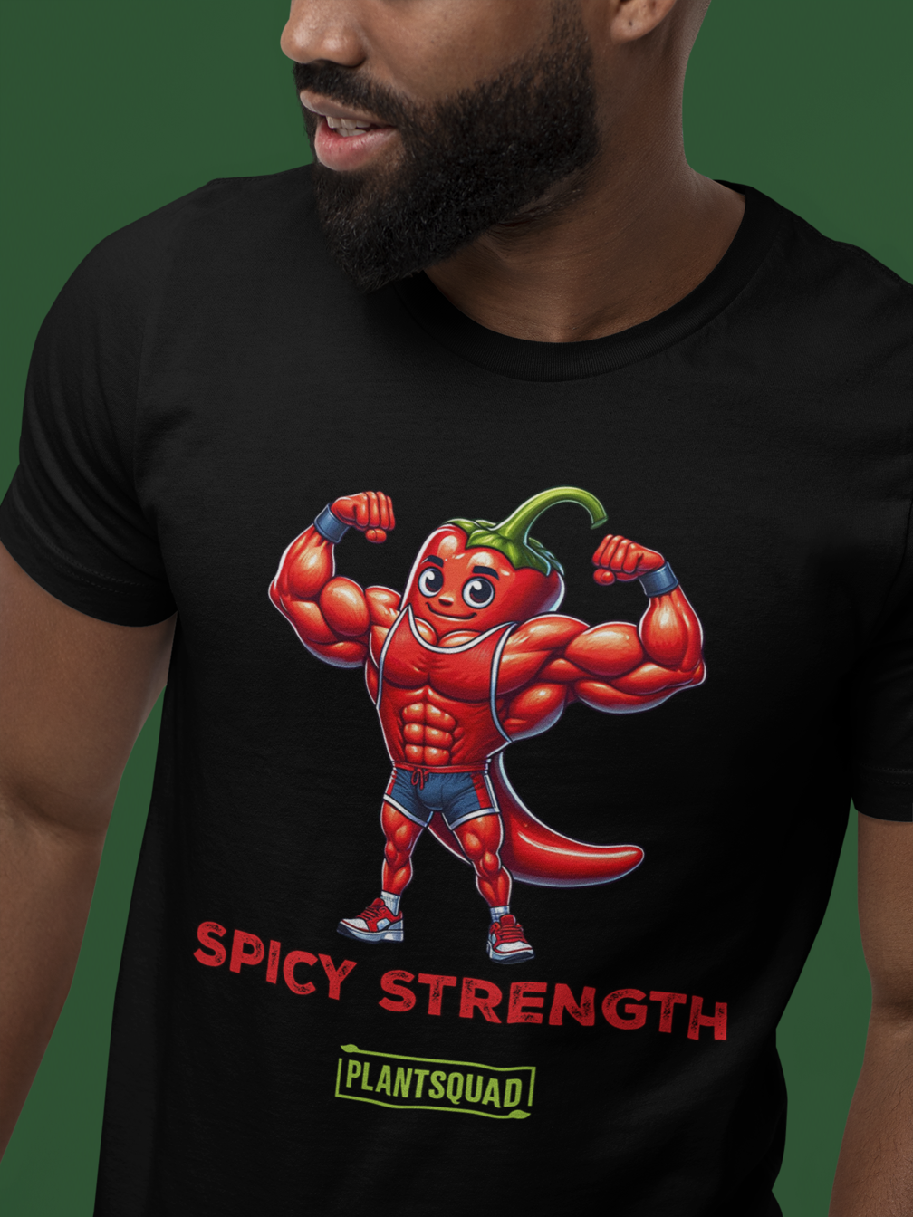 Plantsquad Chilli "Spicy Strength" - Unisex T-Shirt: A black T-shirt featuring a muscular cartoon chili pepper flexing its arms under the words "SPICY STRENGTH" in bold red text. Below that is the green and yellow Plantsquad logo, adding a touch of flair.