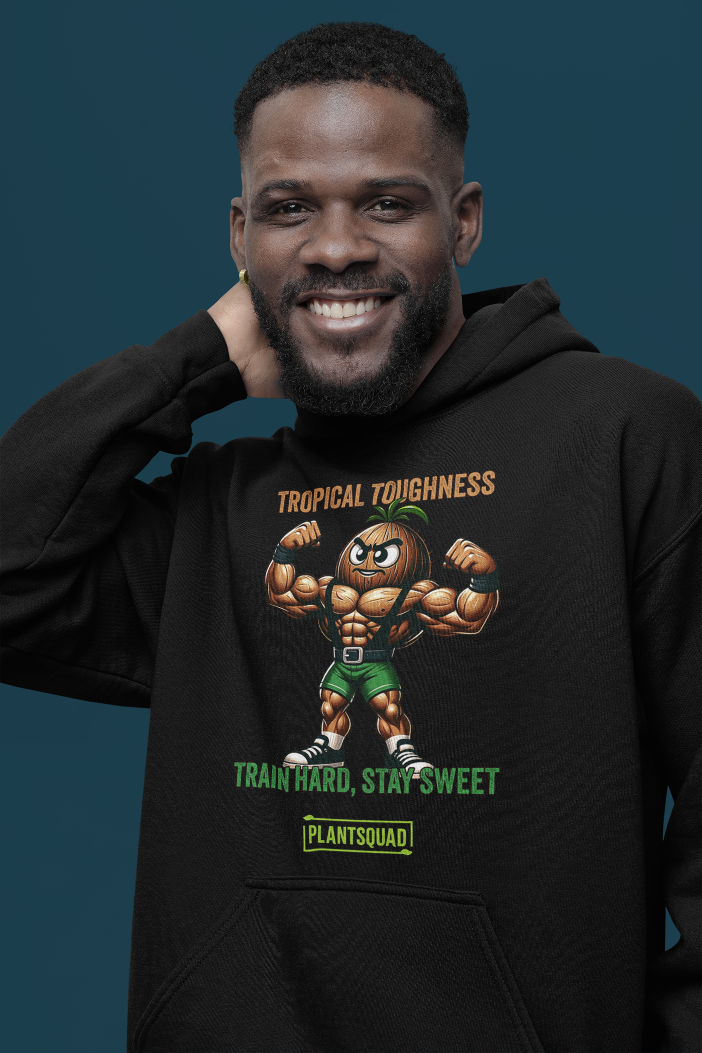 The Plantsquad Coconut "Tropical Toughness Train Hard Stay Sweet" - Unisex Hoodie features a muscular cartoon coconut flexing its biceps, wearing green shorts. Above the coconut, text reads "Tropical Toughness." Below it, text reads "Train Hard, Stay Sweet" with a green banner labeled "PlantSquad." Ideal for those embracing a vegan lifestyle.