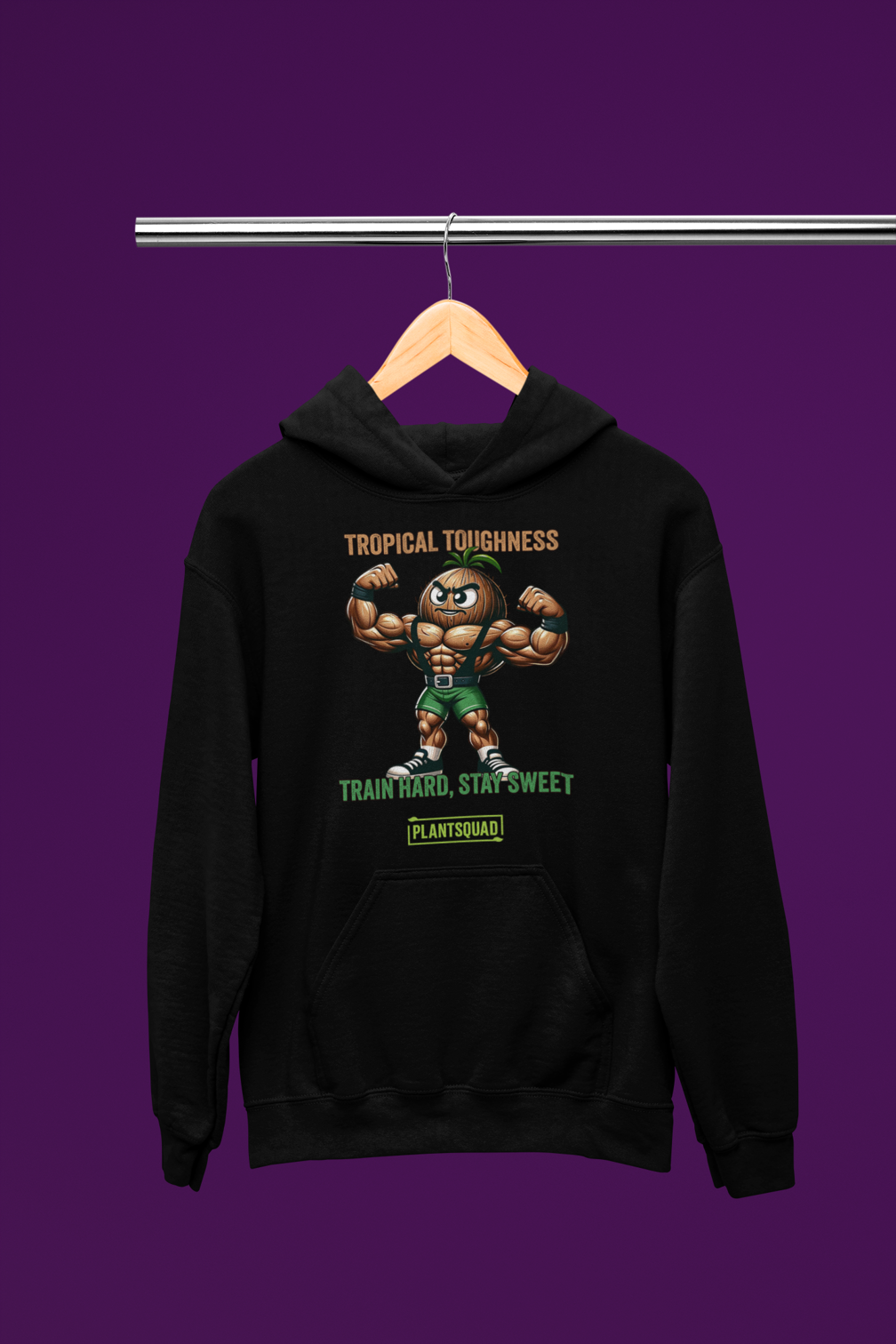 The Plantsquad Coconut "Tropical Toughness Train Hard Stay Sweet" - Unisex Hoodie features a muscular cartoon coconut flexing its biceps, wearing green shorts. Above the coconut, text reads "Tropical Toughness." Below it, text reads "Train Hard, Stay Sweet" with a green banner labeled "PlantSquad." Ideal for those embracing a vegan lifestyle.