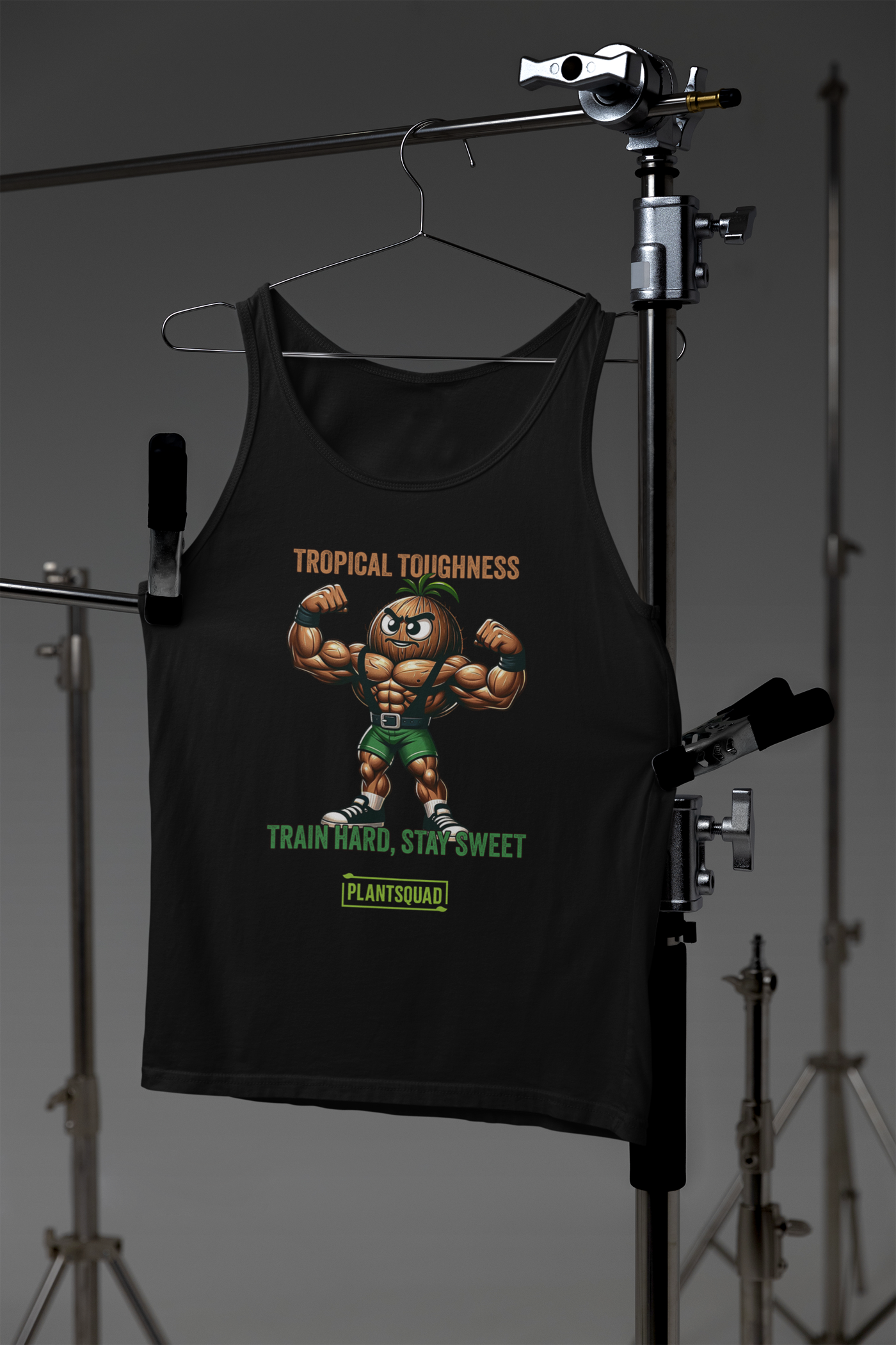 Sure, here's the sentence with the product name replaced:

The Plantsquad Coconut "Tropical Toughness Train Hard Stay Sweet" - Unisex Tank Top is a black sleeveless tank top featuring an illustration of a muscular anthropomorphic pineapple flexing its biceps. The text "Tropical Toughness" is written above the pineapple, and "Train Hard, Stay Sweet" along with "Plant Squad" is written below it—perfect vegan gym wear for a plant-based lifestyle.