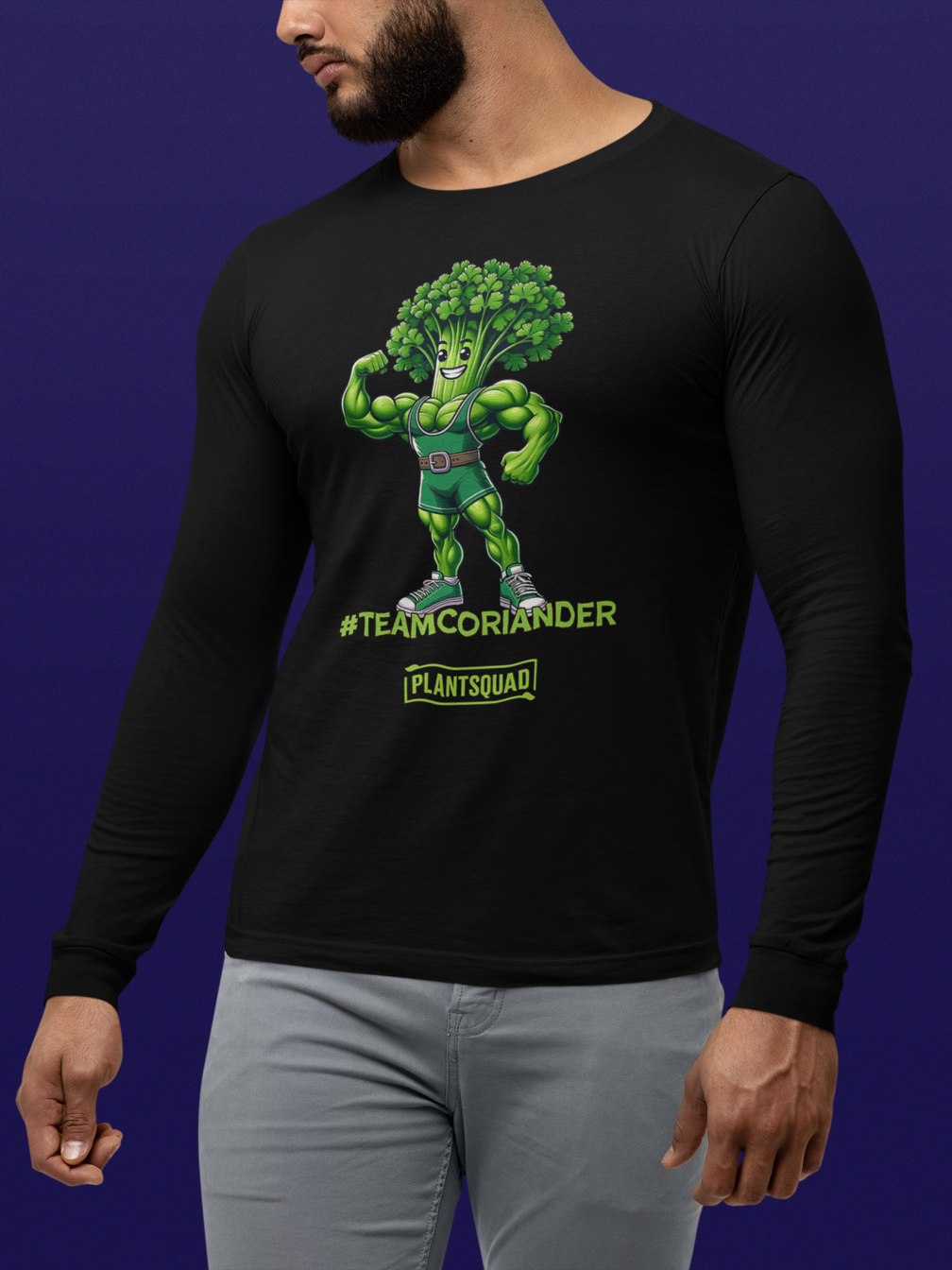 A Plantsquad Coriander "Team Coriander" - Unisex Long Sleeve T-Shirt featuring a muscly coriander cartoon character with a bodybuilder physique and a head of coriander leaves. The text "#TEAMCORIANDER" is displayed below the character, along with the logo "PLANTSQUAD" underneath. Perfect for fitness enthusiasts embracing a vegan lifestyle.