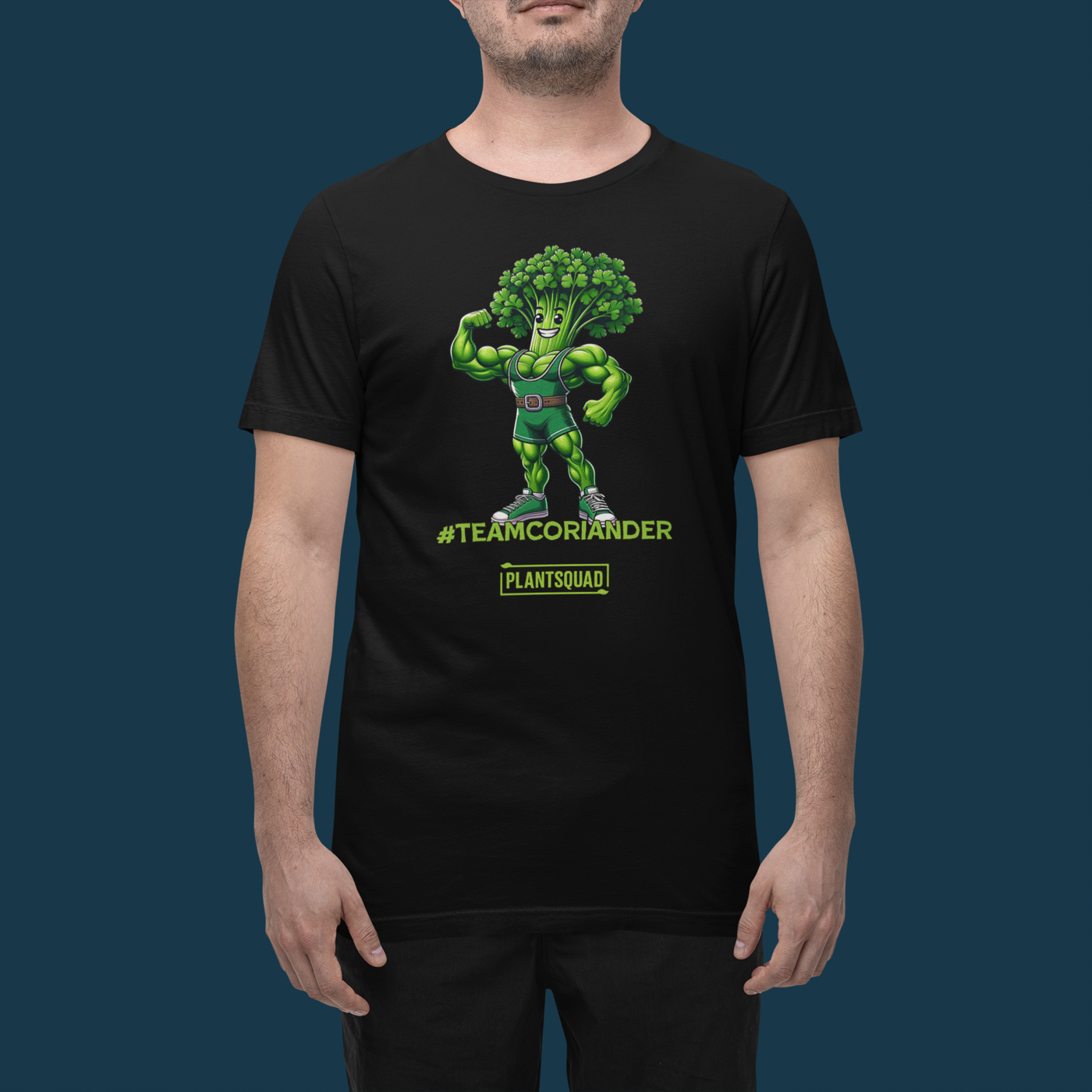 A black t-shirt featuring a cartoon anthropomorphic broccoli character flexing its muscles. The character is wearing a green singlet and sneakers. Text underneath reads "#TEAMCORIANDER" and "PLANTSQUAD" in bright green and yellow lettering, proudly showcasing your plantsquad spirit. This is the Plantsquad Coriander "Team Coriander" - Unisex T-Shirt.