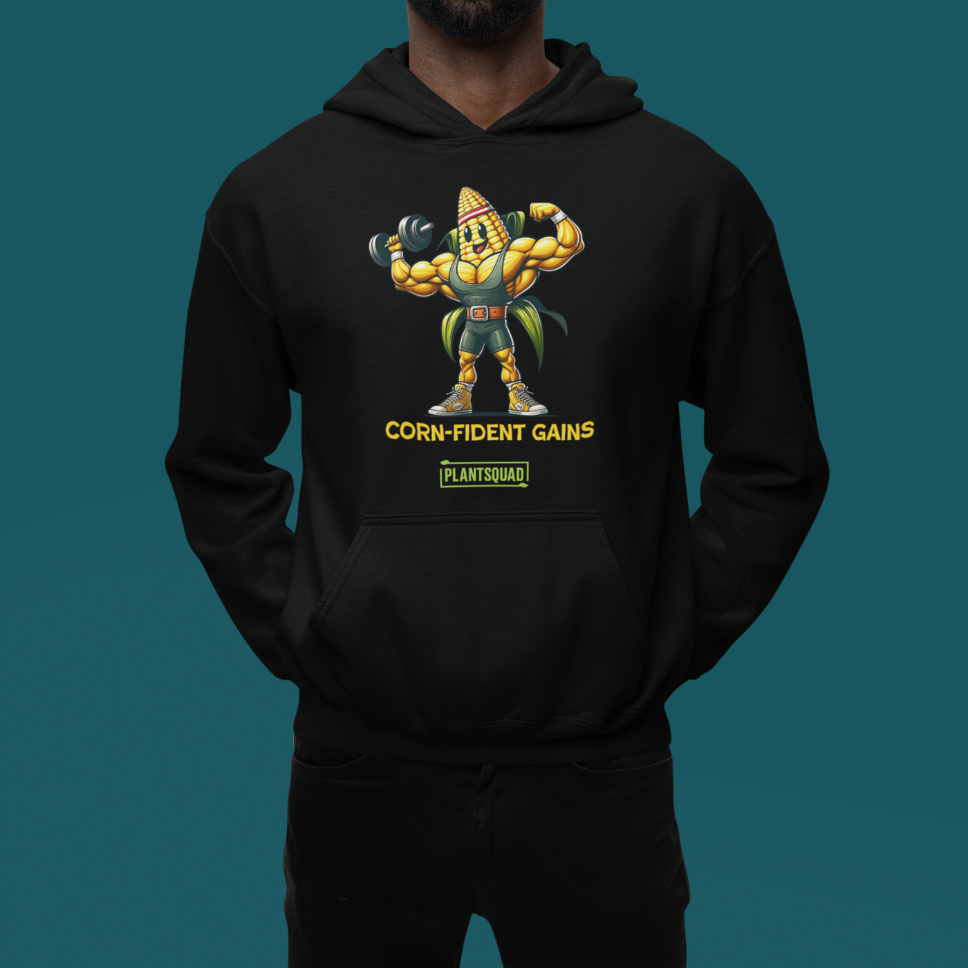 Black hoodie featuring a muscular anthropomorphic corn cob character flexing its biceps. The text beneath the character reads "CORN-fident Gains" with "PLANTSQUAD" in a green box below. Perfect for gym enthusiasts who embrace a plant-based lifestyle, this Plantsquad Corn "Corn-fident Gains" - Unisex Hoodie exudes confidence with every wear.