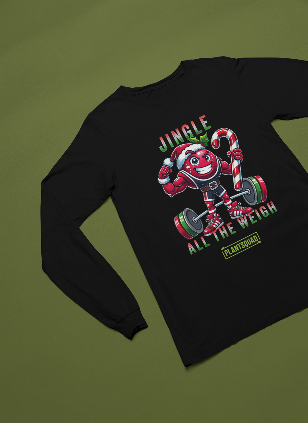 A picture of a long sleeve tee featuring a strong looking cranberry cartoon character flexing its arms holding a candy cane.  A small green logo "PLANTSQUAD" appears above the character, "JINGLE ALL THE WEIGH" below. Perfect for those embracing a plant-based or vegan lifestyle that are into fitness