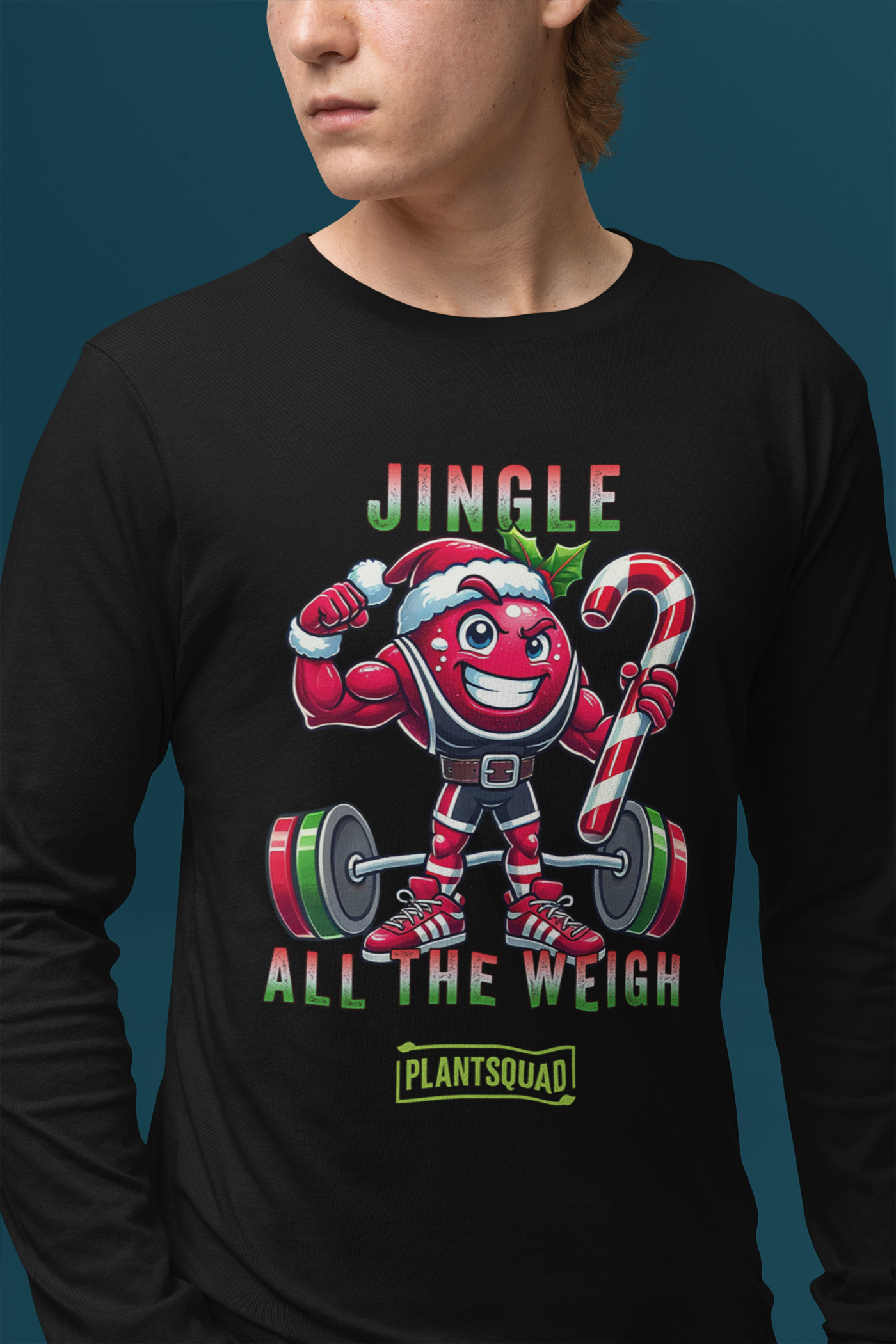 A model featuring a muscled cranberry cartoon character flexing its arms holding a candy cane.  A small green logo "PLANTSQUAD" appears above the character, "JINGLE ALL THE WEIGH" below. Perfect for those embracing a plant-based or vegan lifestyle that are into fitness