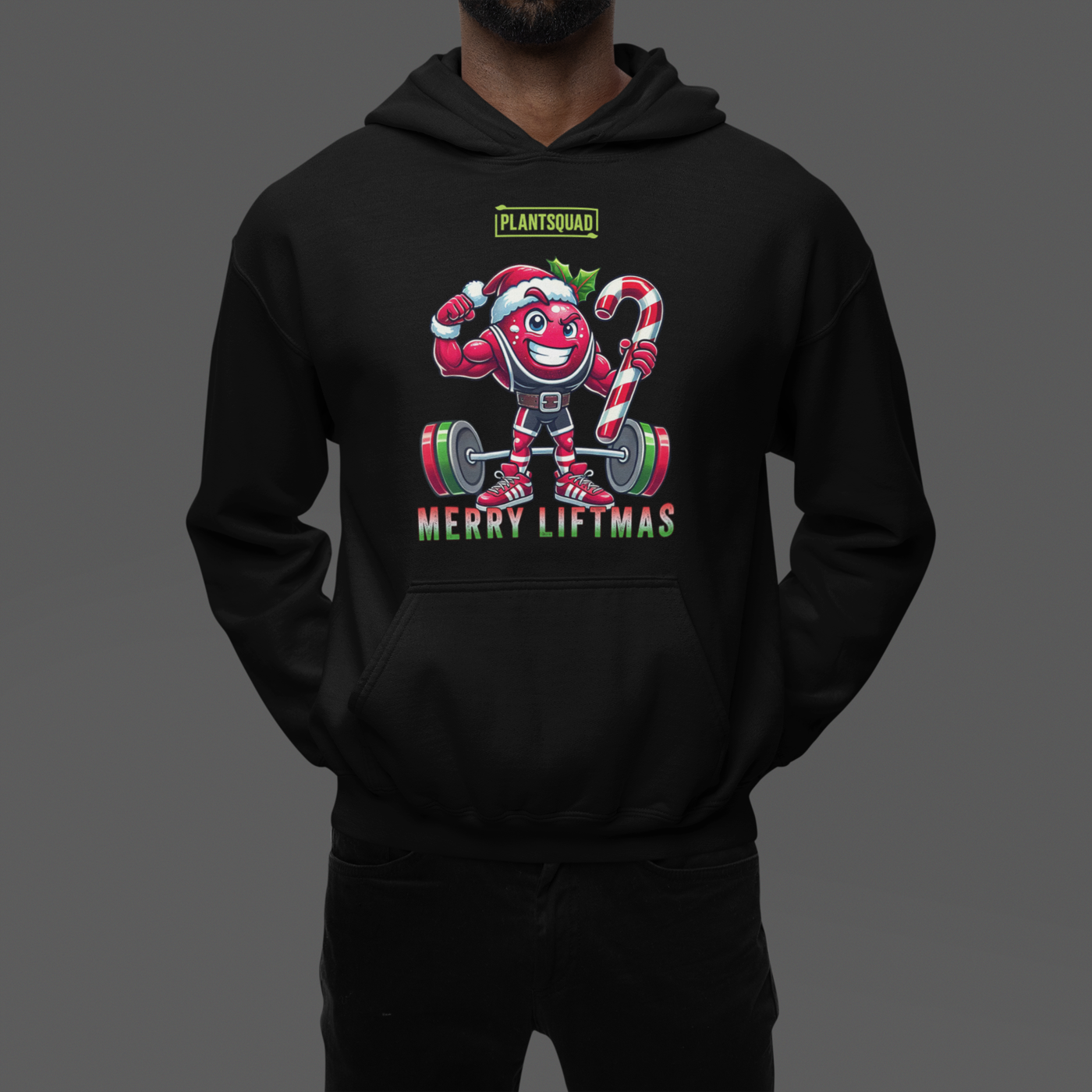 A model featuring a muscled cranberry cartoon character flexing its arms holding a candy cane.  A small green logo "PLANTSQUAD" appears above the character, "MERRY LIFTMAS" below. Perfect for those embracing a plant-based or vegan lifestyle that are into fitness