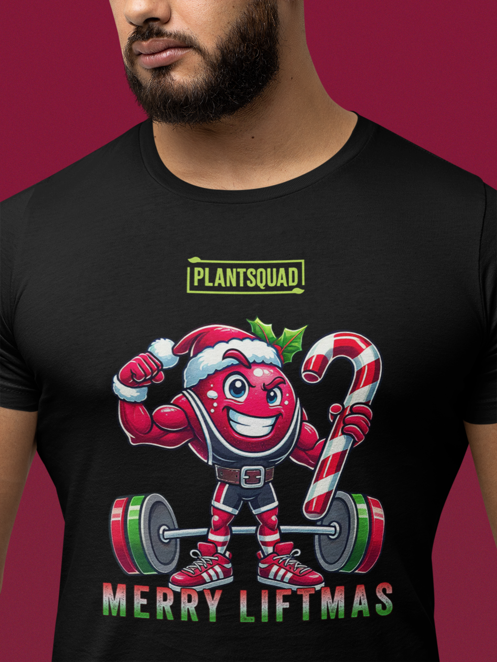 A model featuring a muscled cranberry cartoon character flexing its arms holding a candy cane.  A small green logo "PLANTSQUAD" appears above the character, "MERRY LIFTMAS" below. Perfect for those embracing a plant-based or vegan lifestyle that are into fitness