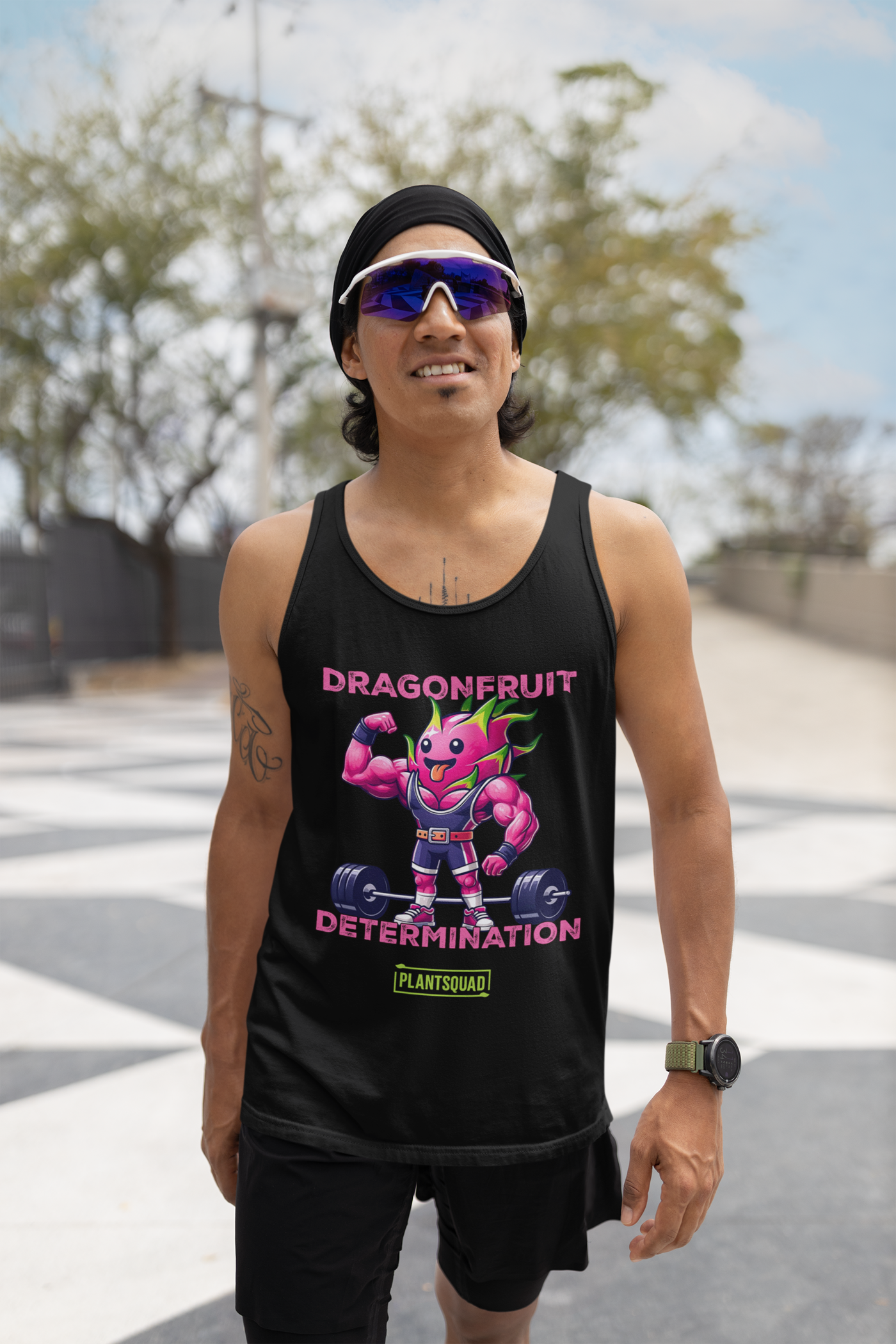 The Plantsquad Dragonfruit "Dragonfruit Determination" - Unisex Tank Top is a sleeveless black tank, showcasing a muscular, anthropomorphic dragon fruit character in a bodybuilding pose. Perfect for intense training sessions, it features "DRAGONFRUIT DETERMINATION" above and below the character, with a "PLANTSQUAD" logo at the bottom.