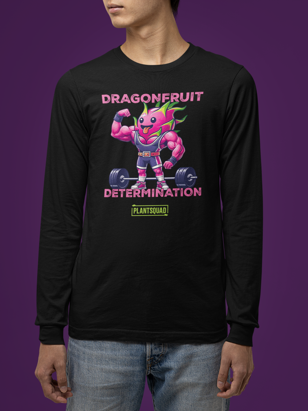 A Plantsquad Dragonfruit "Dragonfruit Determination" - Unisex Long Sleeve T-Shirt featuring a muscular anthropomorphic dragon fruit lifting a barbell. The text above reads "DRAGONFRUIT" and "DETERMINATION," while the text below says "PLANTSQUAD." The vibrant design highlights vegan fitness apparel with pink skin, green leaves, and purple gym attire.