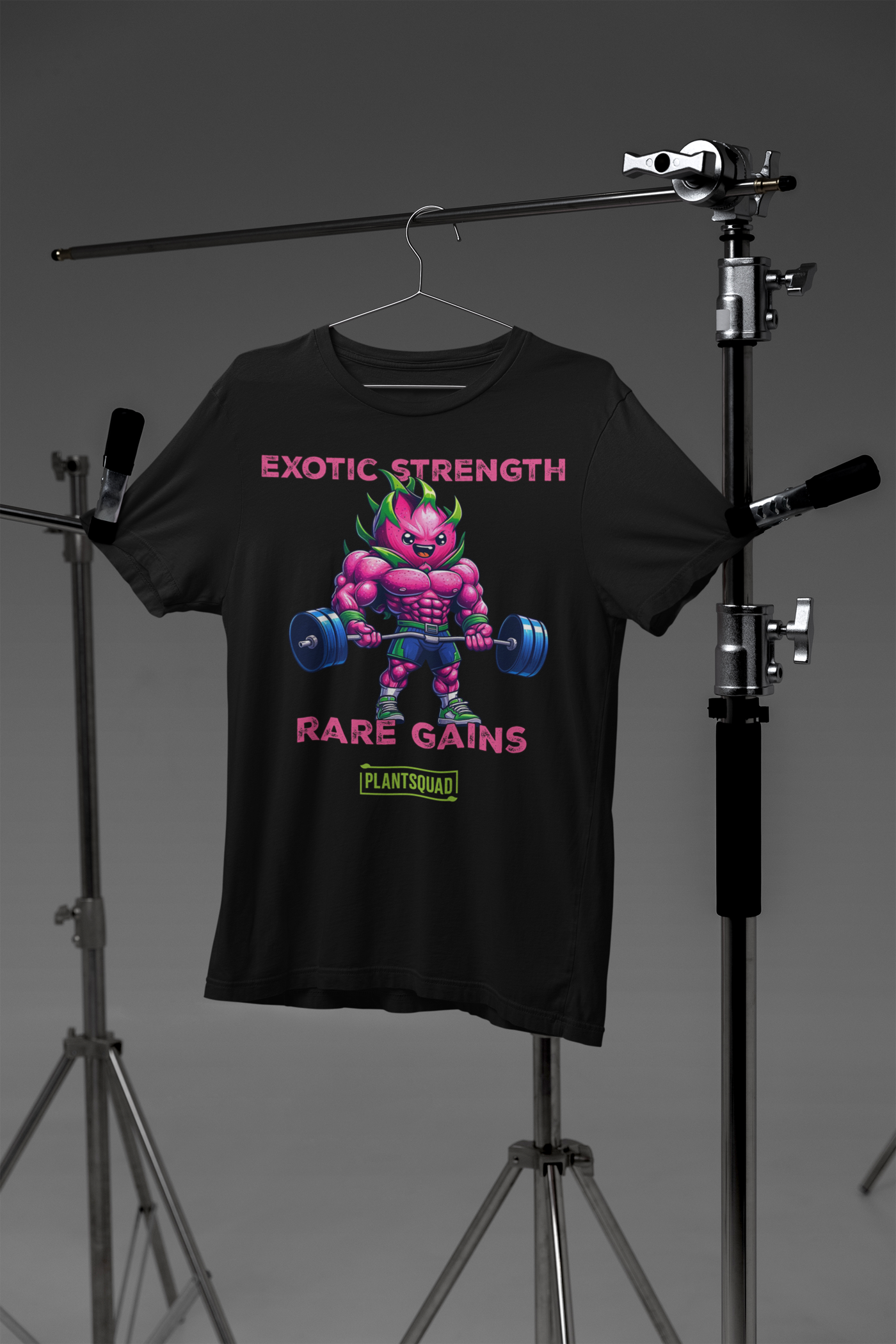 A Plantsquad Dragonfruit "Exotic Strength Rare Gains" - Unisex T-Shirt featuring a muscular anthropomorphic plant figure lifting a barbell. The character boasts bright purple skin and green leaves. Above the figure, text reads "EXOTIC STRENGTH," and below, "RARE GAINS." A small logo at the bottom proudly displays "PLANTSQUAD.