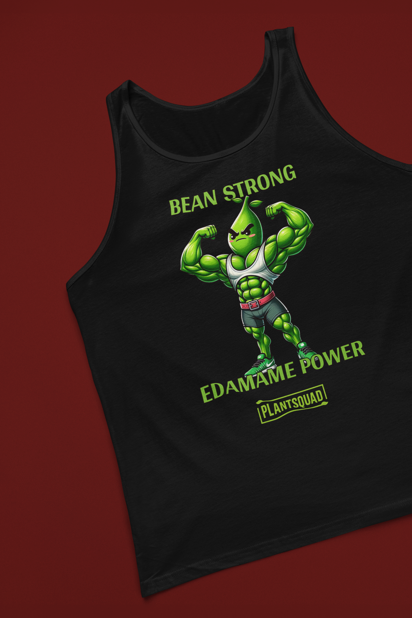 A black Plantsquad Edamame "Bean Strong Edamame Power" - Unisex Tank Top featuring an illustration of an anthropomorphic edamame bean flexing its arm muscles, perfect for gym enthusiasts. Above it in green text, it says "BEAN STRONG," and below it, "EDAMAME POWER." At the bottom, there is a green logo with the text "PLANTSQUAD." Embrace the vegan lifestyle!