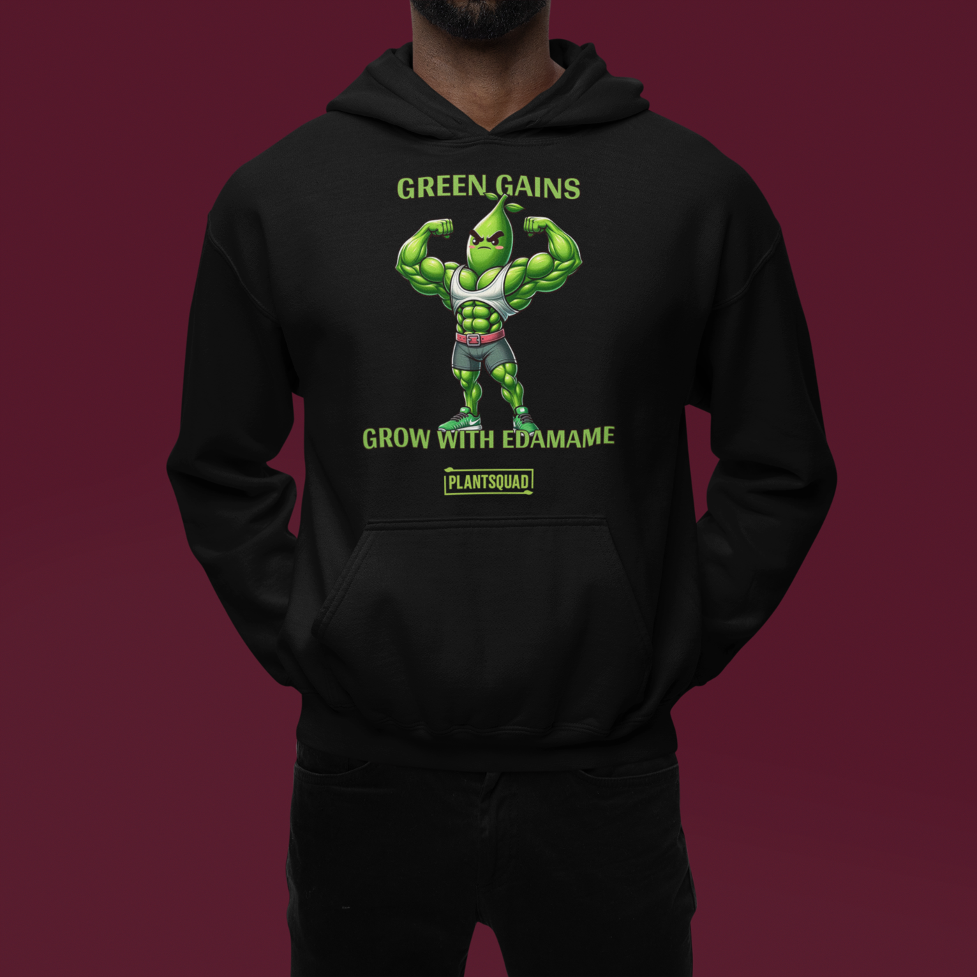 A Plantsquad Edamame "Green Gains Grow With Edamame" - Unisex Hoodie featuring a muscular, cartoon edamame bean character flexing its arms. The text above the character reads "GREEN GAINS," and below it reads "GROW WITH EDAMAME." Perfect for a Vegan lifestyle, the "PLANTSQUAD" logo is displayed at the bottom.