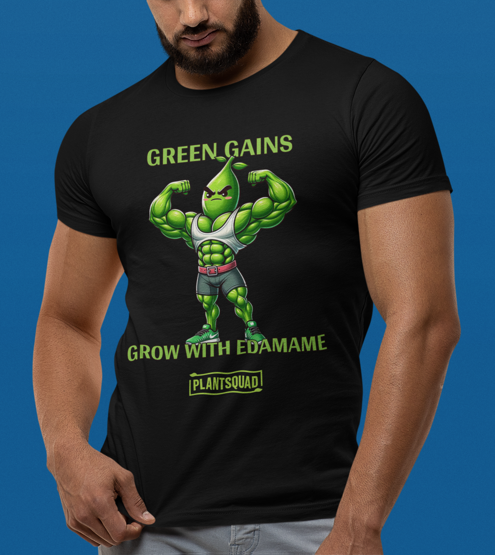 A Plantsquad Edamame "Green Gains Grow With Edamame" - Unisex T-Shirt featuring a flexing anthropomorphic edamame character with muscular arms. The text above reads "GREEN GAINS" and below "GROW WITH EDAMAME." The bottom text, showcased in a small, yellow box, proudly displays "plantsquad".