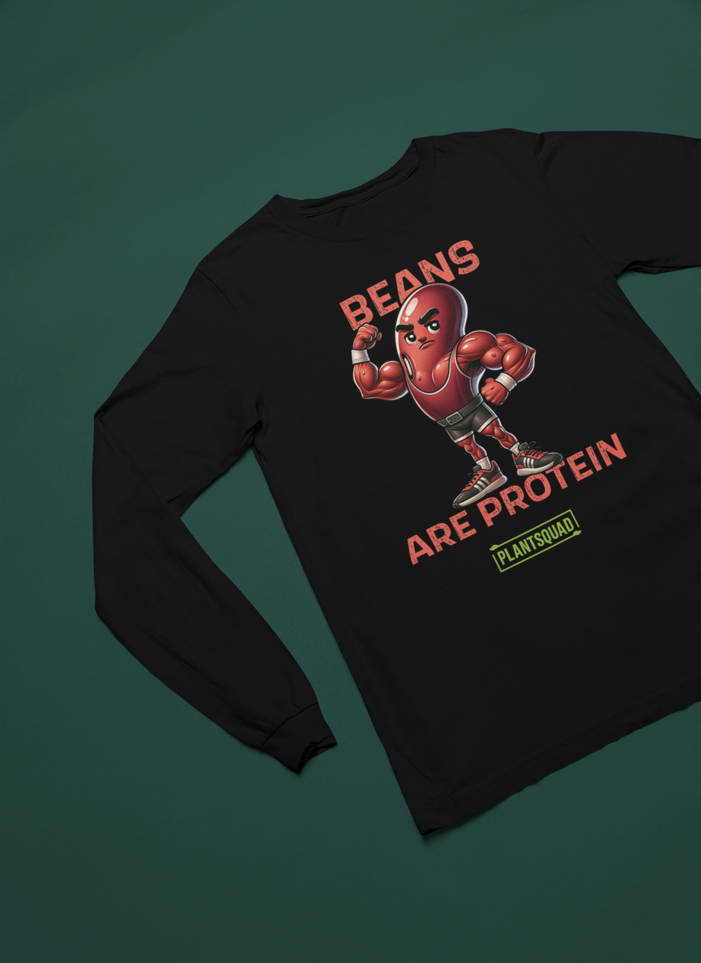 A Plantsquad Kidney Bean "Bean Strong Lift Long" - Unisex Long Sleeve T-Shirt featuring a muscular cartoon kidney bean character flexing its biceps. Above the character, the text reads "BEAN STRONG," and below, "LIFT LONG." Crafted from comfortable fabric, it's perfect for fitness enthusiasts embracing a vegan lifestyle. At the bottom, a green rectangle displays "PLANTSQUAD" in all caps.