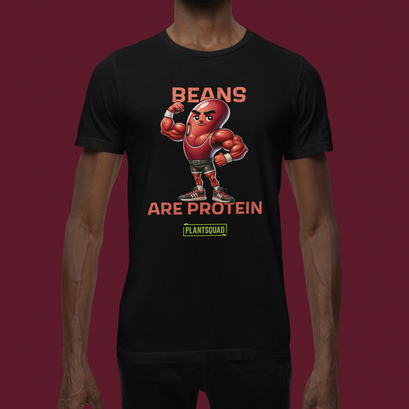 A black t-shirt featuring a muscular cartoon bean character with arms flexed. Above the character, red text reads "Beans," and below it, "Are Protein" is displayed in orange. Beneath that, the word "Plantsquad" is prominently written in green — Plantsquad Kidney Bean "Beans Are Protein" - Unisex T-Shirt.