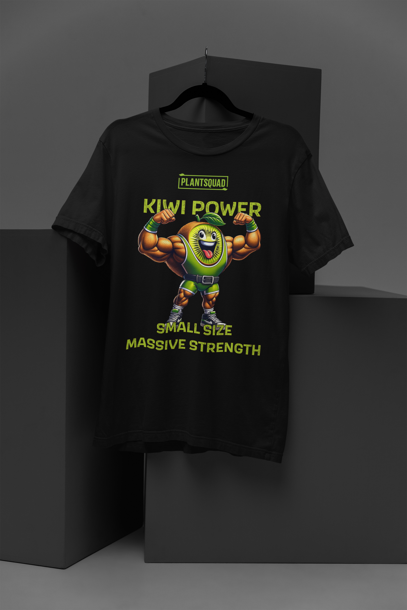 A Plantsquad Kiwi "Kiwi Power Small Size Massive Strength" - Unisex T-Shirt featuring a muscly kiwi cartoon character flexing its arms. Above the character, the text reads, "PLANTSQUAD KIWI POWER." Below the character, the text reads, "SMALL SIZE MASSIVE STRENGTH," perfect for a vegan lifestyle vibe.