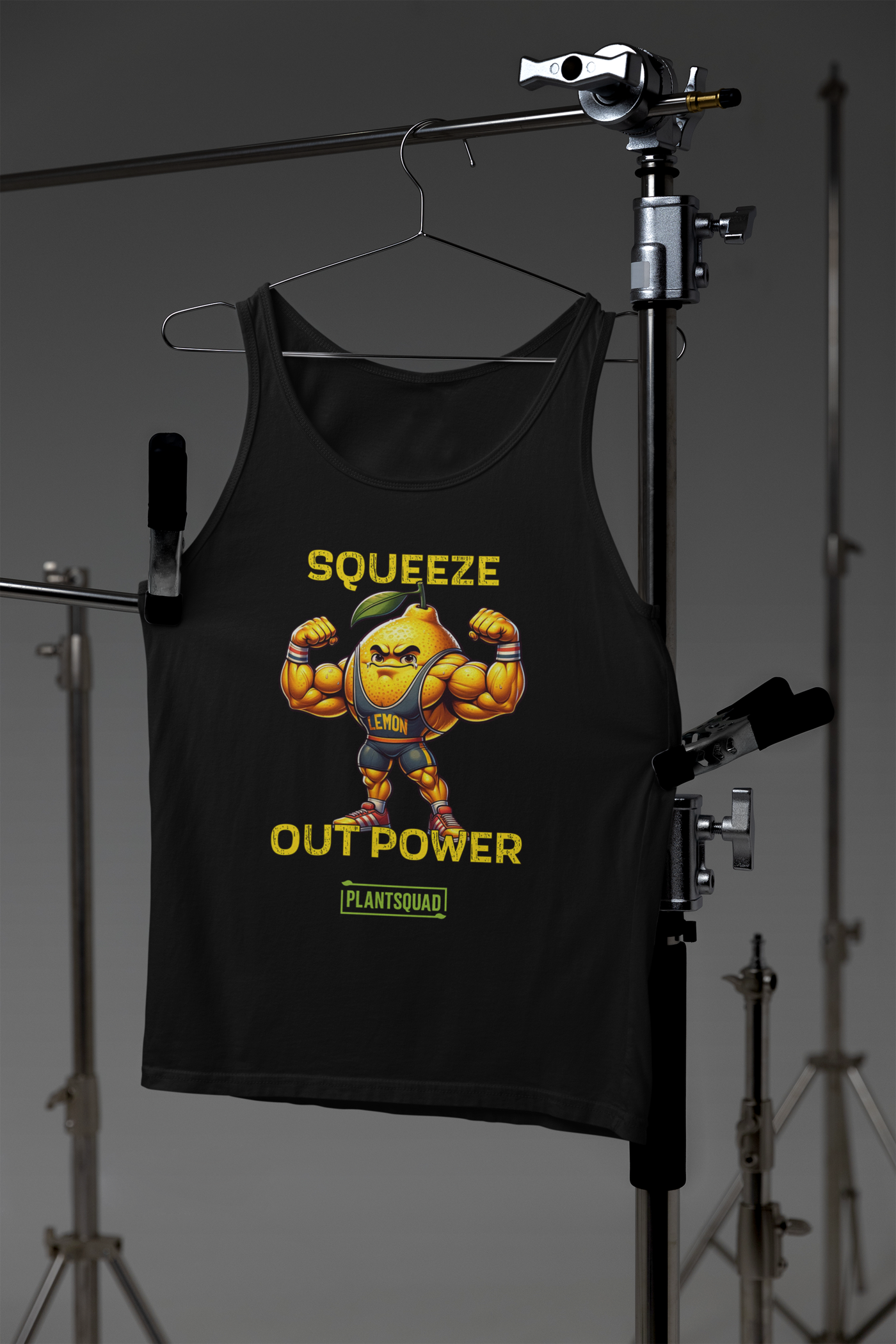 A Plantsquad Lemon "Squeeze Out Power" - Unisex Tank Top featuring a muscular cartoon lemon flexing its arms. The text above the lemon reads "SQUEEZE OUT POWER," and below it is "PLANTSQUAD." Perfect for anyone embracing a plant-based lifestyle, the lemon character is wearing a headband and sneakers.