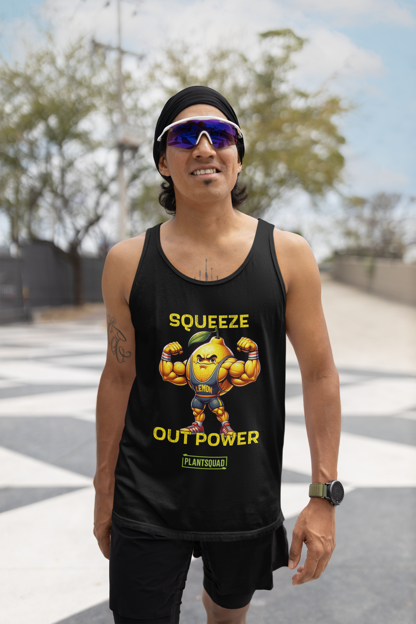 A Plantsquad Lemon "Squeeze Out Power" - Unisex Tank Top featuring a muscular cartoon lemon flexing its arms. The text above the lemon reads "SQUEEZE OUT POWER," and below it is "PLANTSQUAD." Perfect for anyone embracing a plant-based lifestyle, the lemon character is wearing a headband and sneakers.