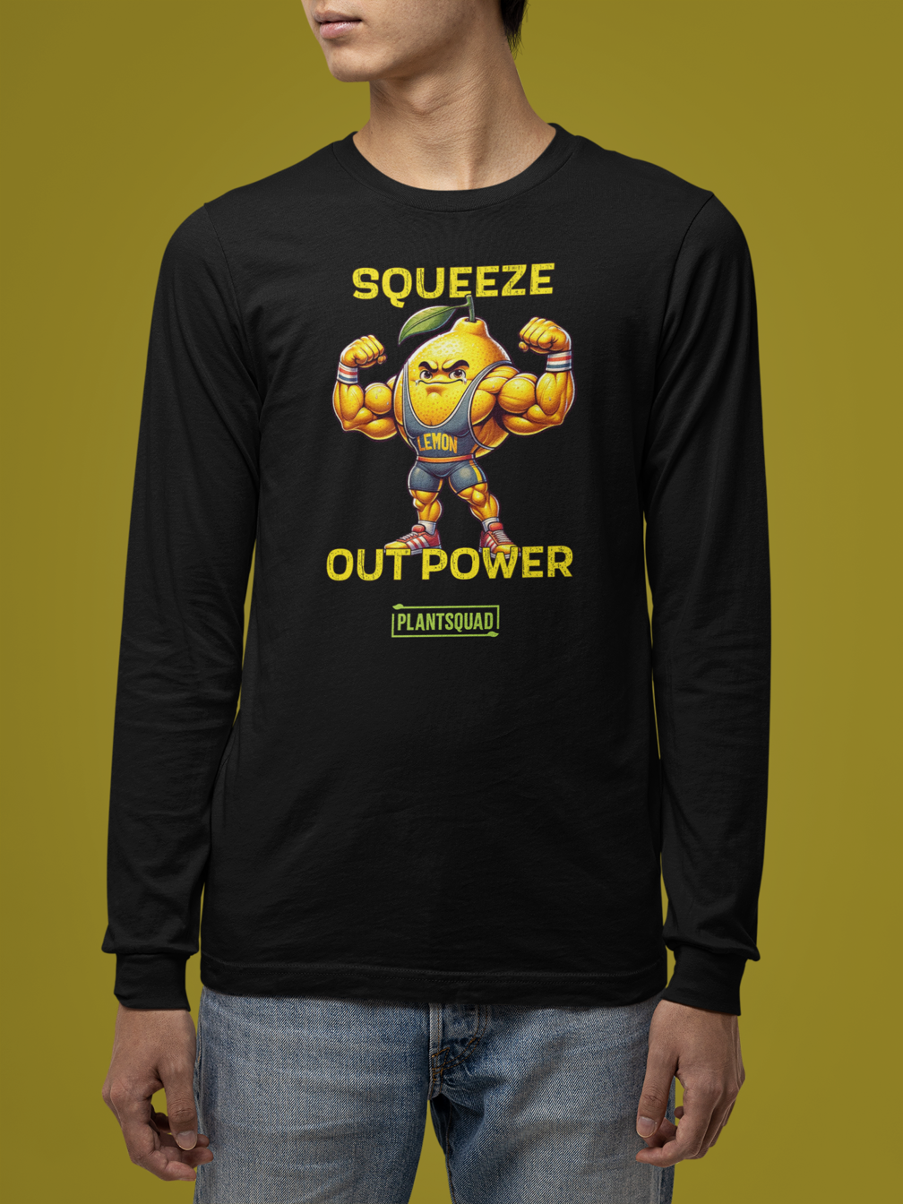 The Plantsquad Lemon "Squeeze Out Power" - Unisex Long Sleeve T-Shirt features a muscly lemon cartoon flexing its arms with 'Squeeze Out Power' written above and below in yellow text. The word 'Plantsquad' appears at the bottom in a green box, perfect for fitness enthusiasts embracing a vegan lifestyle.