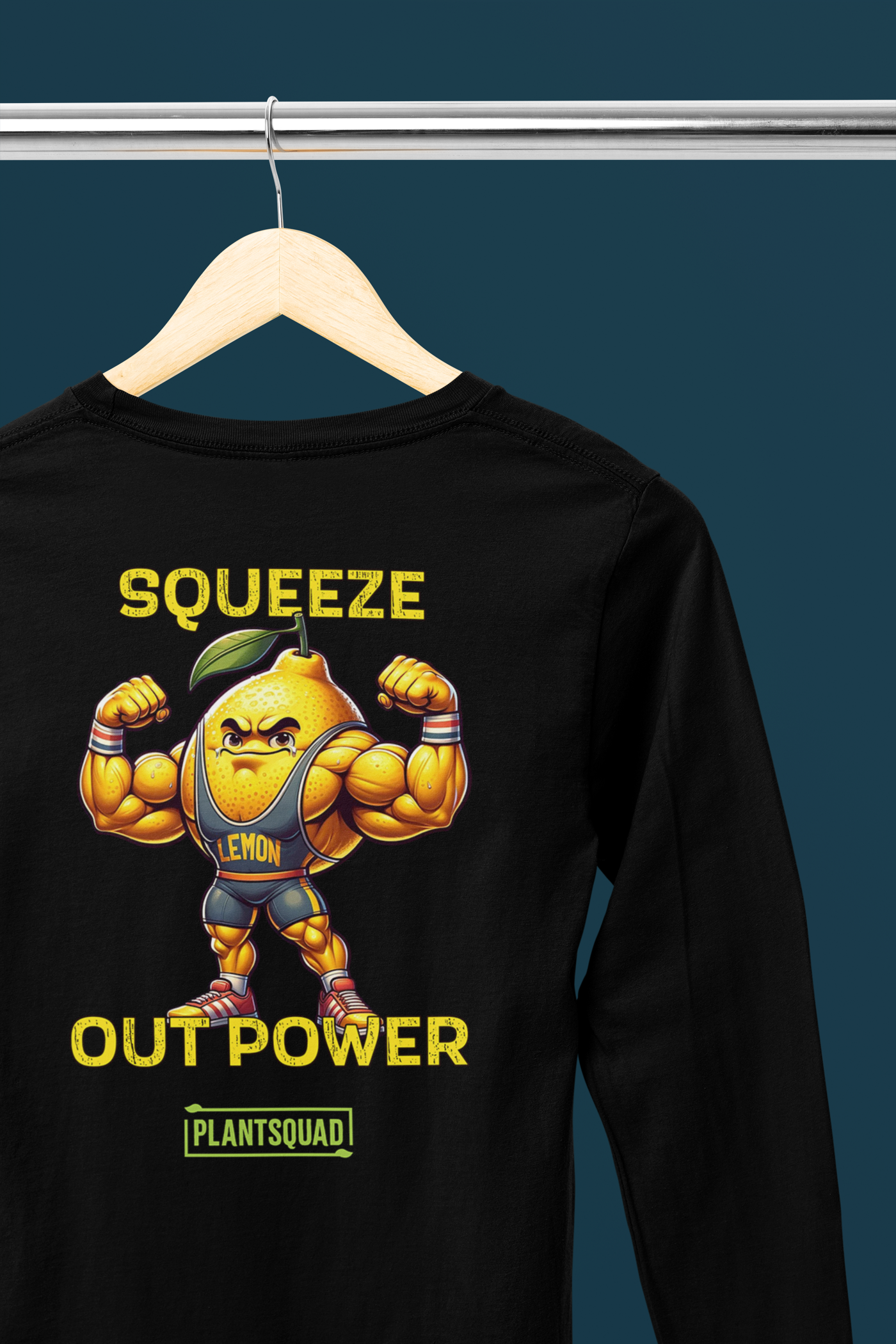 The Plantsquad Lemon "Squeeze Out Power" - Unisex Long Sleeve T-Shirt features a muscly lemon cartoon flexing its arms with 'Squeeze Out Power' written above and below in yellow text. The word 'Plantsquad' appears at the bottom in a green box, perfect for fitness enthusiasts embracing a vegan lifestyle.