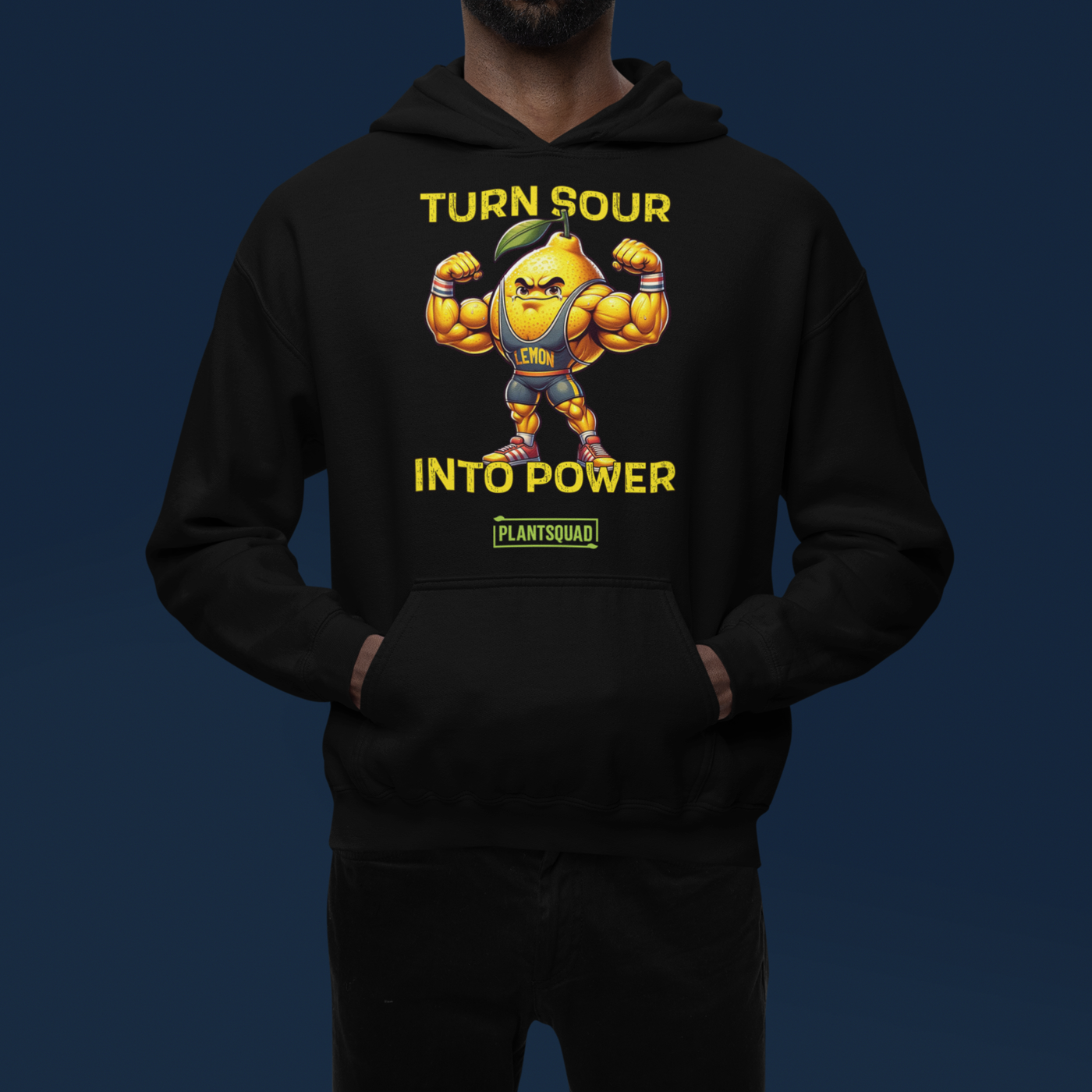 A Plantsquad Lemon "Turn Sour Into Power" - Unisex Hoodie featuring a muscular, animated lemon character flexing its arms. The text above the lemon reads "TURN SOUR," and the text below reads "INTO POWER." The word "LEMON" is on the character's chest. The bottom text reads "PLANTSQUAD," perfect for your vegan gym wear collection.