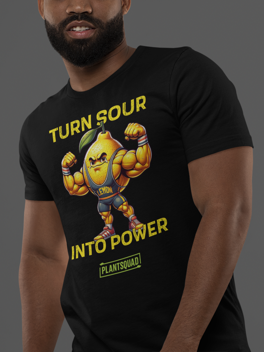 A black gym T-shirt featuring a muscly lemon cartoon flexing its biceps. Yellow text above reads "TURN SOUR," and below says "INTO POWER." A green and yellow label at the bottom displays the word "PLANTSQUAD," perfect for showcasing your Vegan lifestyle. This is the Plantsquad Lemon "Turn Sour Into Power" - Unisex T-Shirt.