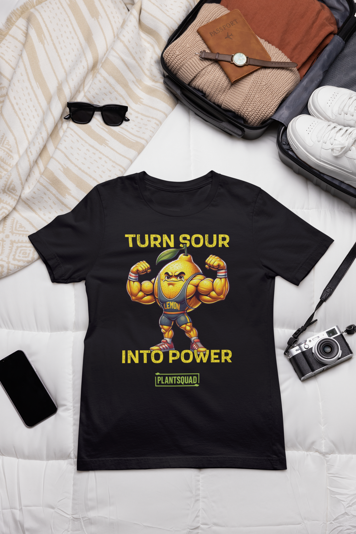 A black gym T-shirt featuring a muscly lemon cartoon flexing its biceps. Yellow text above reads "TURN SOUR," and below says "INTO POWER." A green and yellow label at the bottom displays the word "PLANTSQUAD," perfect for showcasing your Vegan lifestyle. This is the Plantsquad Lemon "Turn Sour Into Power" - Unisex T-Shirt.