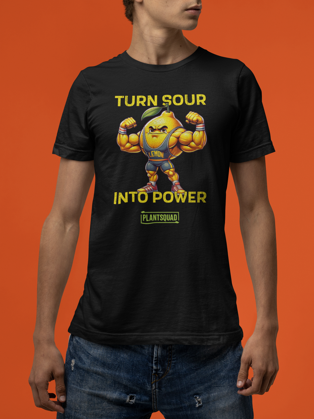 A black gym T-shirt featuring a muscly lemon cartoon flexing its biceps. Yellow text above reads "TURN SOUR," and below says "INTO POWER." A green and yellow label at the bottom displays the word "PLANTSQUAD," perfect for showcasing your Vegan lifestyle. This is the Plantsquad Lemon "Turn Sour Into Power" - Unisex T-Shirt.