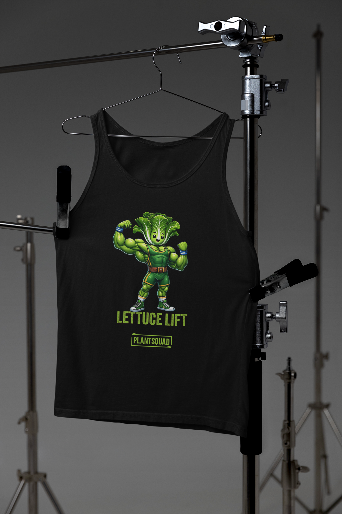 A Plantsquad Lettuce "Lettuce Lift" - Unisex Tank Top featuring a muscular cartoon lettuce character flexing its arms. Below the character, the text reads "LETTUCE LIFT" and "PLANTSQUAD" in green letters, perfect for showcasing your plant-based lifestyle and dedication to vegan gym apparel.