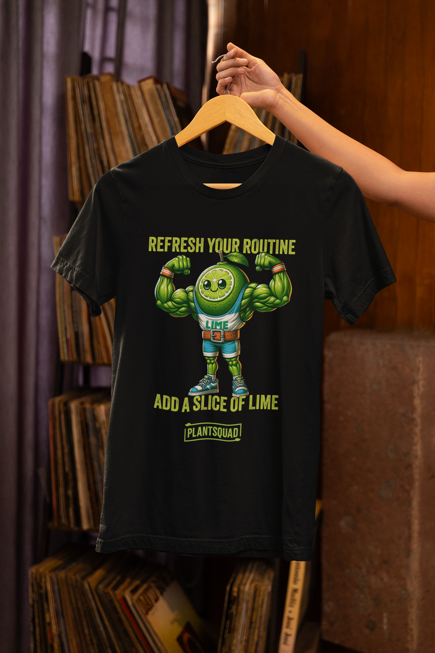 A black Plantsquad Lime "Refresh Your Routine Add A Slice Of Lime" - Unisex T-Shirt featuring an image of a muscular lime slice character wearing sports attire with the number 93. Above the character, the text reads "Refresh Your Routine," and below, "Add a Slice of Lime." At the bottom, the word "Plant Squad" is displayed, promoting a plant-based lifestyle.