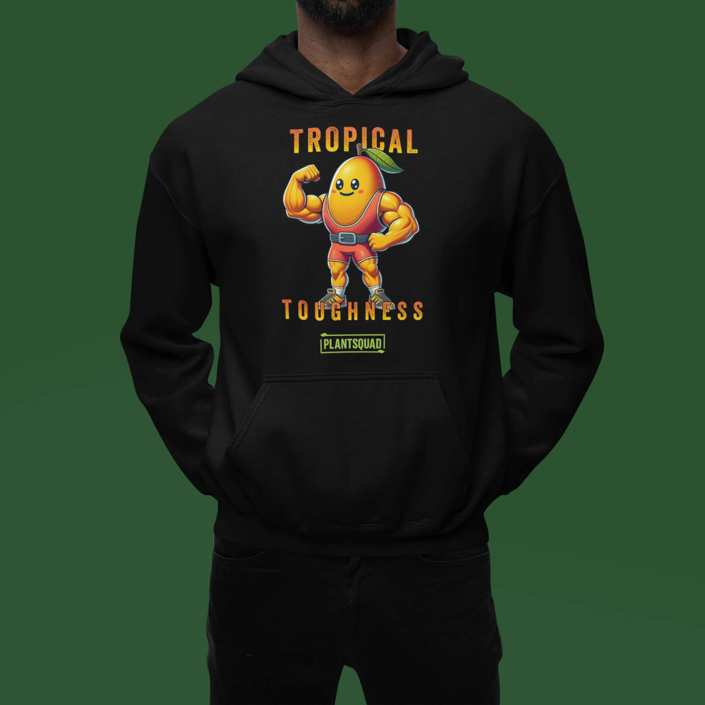 A Plantsquad Mango "Tropical Toughness" - Unisex Hoodie features a muscular, anthropomorphic mango character wearing superhero gear. The character is flexing its muscles, showcasing the benefits of a vegan lifestyle. Above it, text reads "Tropical Toughness," and below, a green label says "PLANTSQUAD.