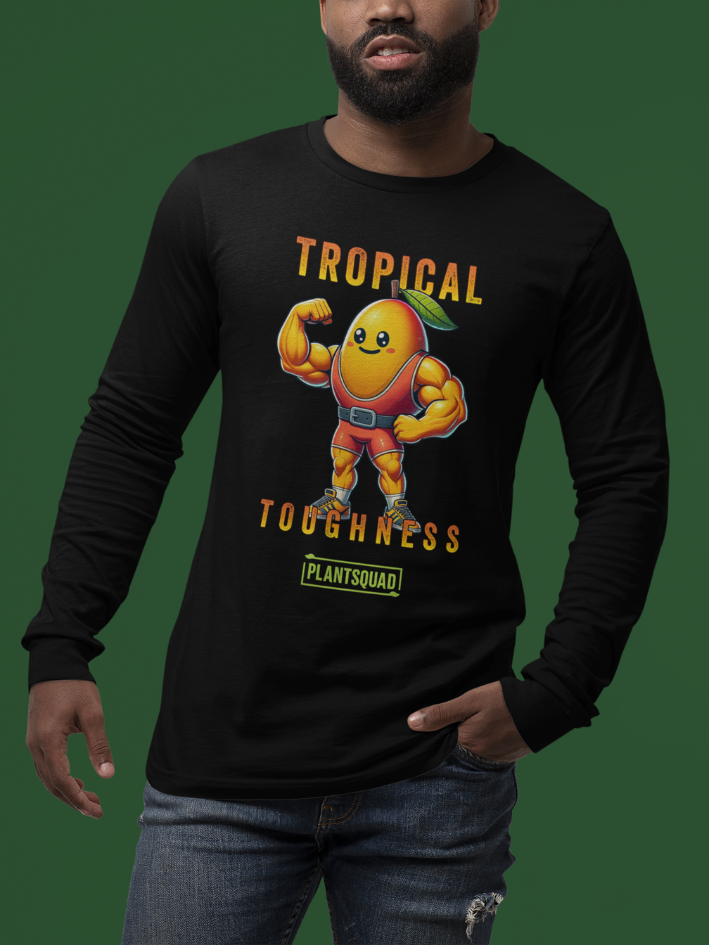 The Plantsquad Mango "Tropical Toughness" - Unisex Long Sleeve T-Shirt features a muscular, animated mango character dressed in red workout gear. The text "Tropical Toughness" is printed above and below the mango, with "Plantsquad" at the bottom. Perfect for fitness enthusiasts embracing a vegan lifestyle.