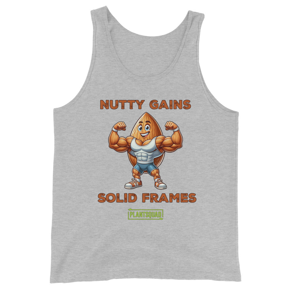 This Plantsquad Almond "Nutty Gains Solid Frames" - Unisex Tank Top features a buff, anthropomorphic almond flexing its muscles. Above it, in bold orange text, reads "NUTTY GAINS." Below, it says "SOLID FRAMES." At the bottom is a green rectangular logo with the text "PLANTSQUAD," perfect for showcasing your vegan lifestyle.