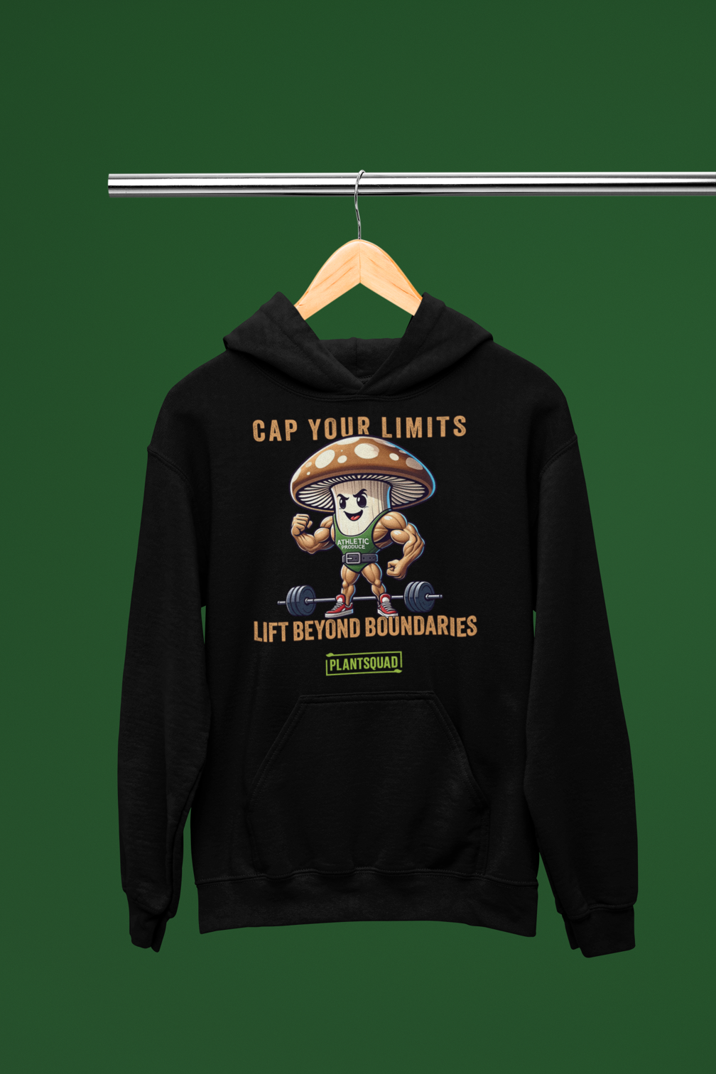 The Plantsquad Mushroom "Cap Your Limits Lift Beyond Boundaries" - Unisex Hoodie is a black weight lifting hoodie featuring a muscular cartoon mushroom character lifting weights. Text above reads "Cap Your Limits" and below reads "Lift Beyond Boundaries." Perfect for embracing plant-based fitness, it features a green logo with the text "PLANTSQUAD" beneath the mushroom.