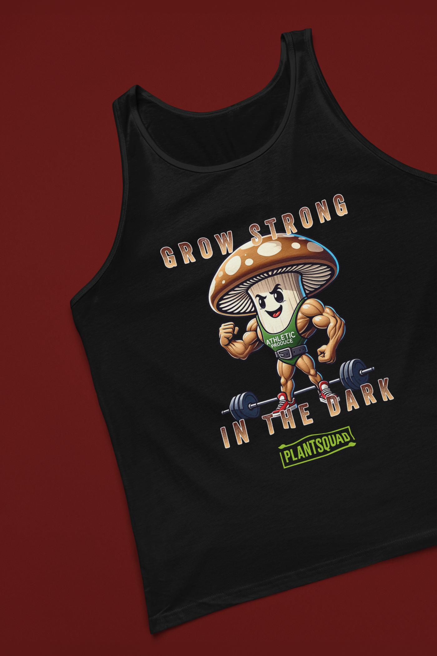 A black Plantsquad Mushroom "Grow Strong In The Dark" - Unisex Tank Top features a cartoon mushroom lifting weights with muscular arms. Text above and below the mushroom reads, "Grow Strong in the Dark - PlantSquad". Perfect for gym enthusiasts embracing a plant-based lifestyle, the mushroom sports a green athletic shirt with "ATHLETIC" on it.