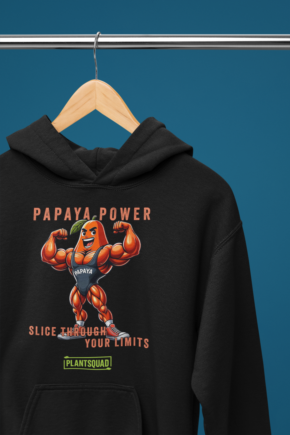 Plantsquad Payapa "Papaya Power Slice Through Your Limits" - Unisex Hoodie, displaying an illustrated muscular orange papaya character flexing, accompanied by the text "Papaya Power" at the top. Below the character, the text reads "Slice Through Your Limits." Perfect for your vegan lifestyle and weight lifting sessions, it features a green logo labeled "Plantsquad.