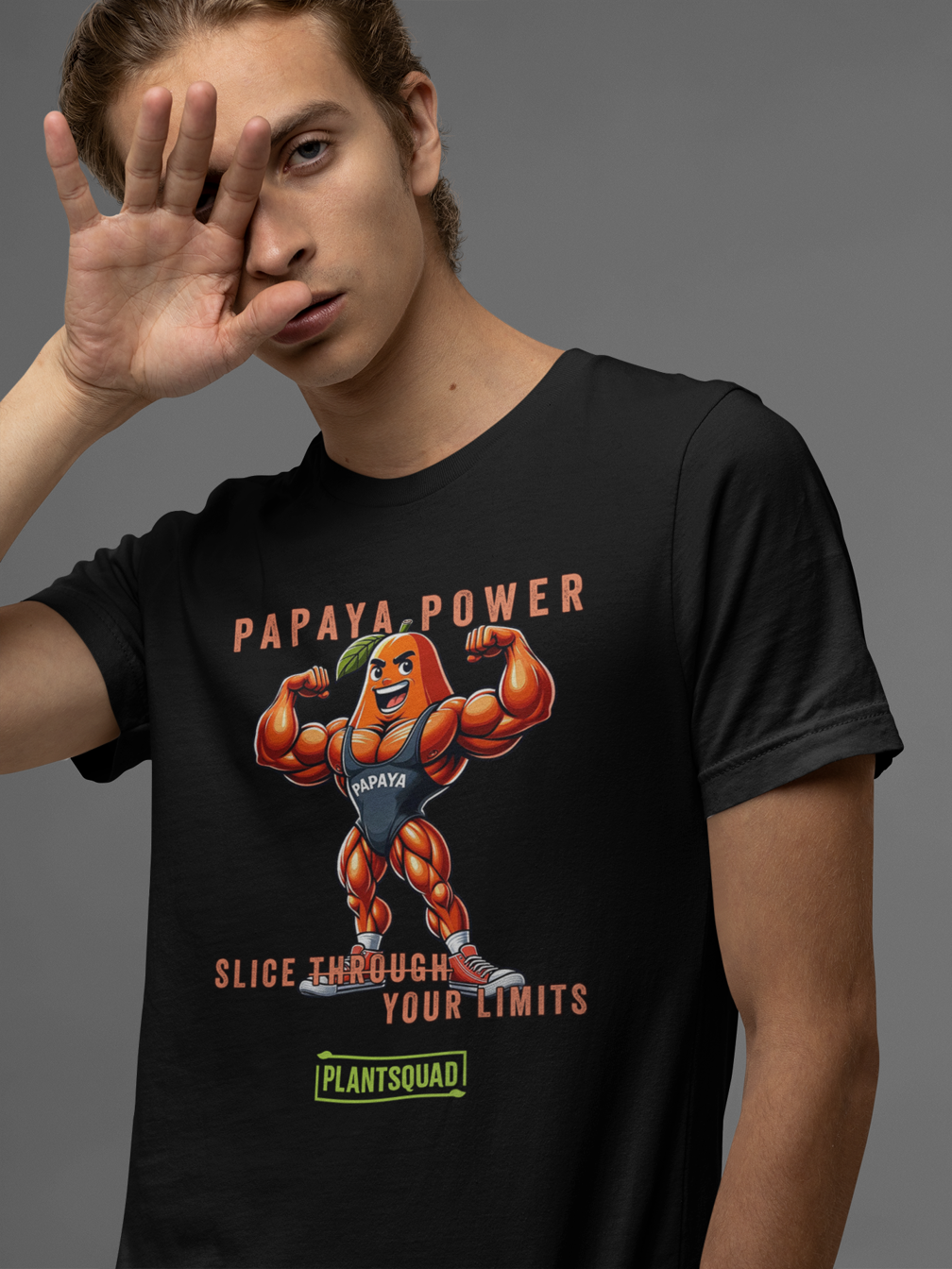 A black Plantsquad Papaya "Papaya Power Slice Through Your Limits" - Unisex T-Shirt featuring a muscular cartoon papaya flexing its arms with the text "PAPAYA POWER" above. Below, the phrase "SLICE THROUGH YOUR LIMITS" is written, celebrating a vegan lifestyle for fitness enthusiasts, with the brand name "PLANTSQUAD" at the bottom.