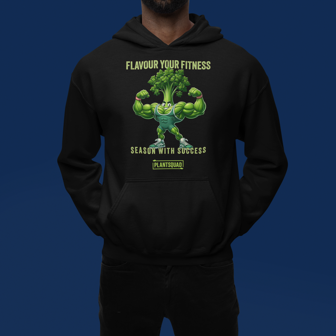 A black vegan hoodie featuring a muscular, anthropomorphic broccoli character flexing its arms. Above the character, the text reads "Flavour Your Fitness," and below it says "Season With Success." The "PLANTSQUAD" logo is displayed at the bottom, perfect for plant-based fitness enthusiasts. This is the Plantsquad Parsley "Flavour Your Fitness Season With Success" - Unisex Hoodie.