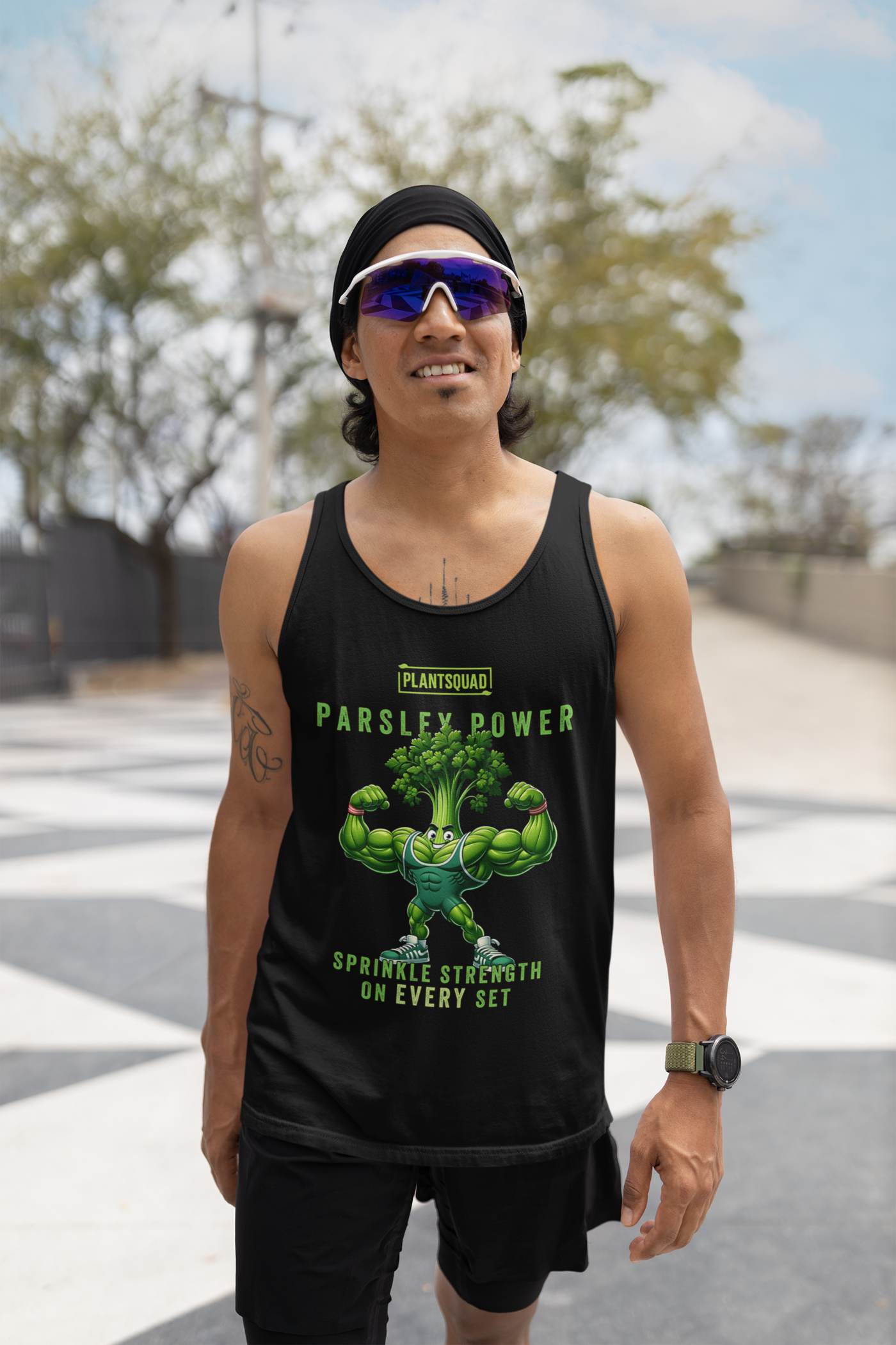 A black tank top features an illustration of a muscular anthropomorphic parsley plant flexing its biceps. Above the character, text reads "PLANTSQUAD PARSLEY POWER," and below it, the text says "SPRINKLE STRENGTH ON EVERY SET." Perfect for gym enthusiasts embracing a plant-based lifestyle, the Plantsquad Parsley "Parsley Power Sprinkle Strength On Every Set" - Unisex Tank Top is a must-have.