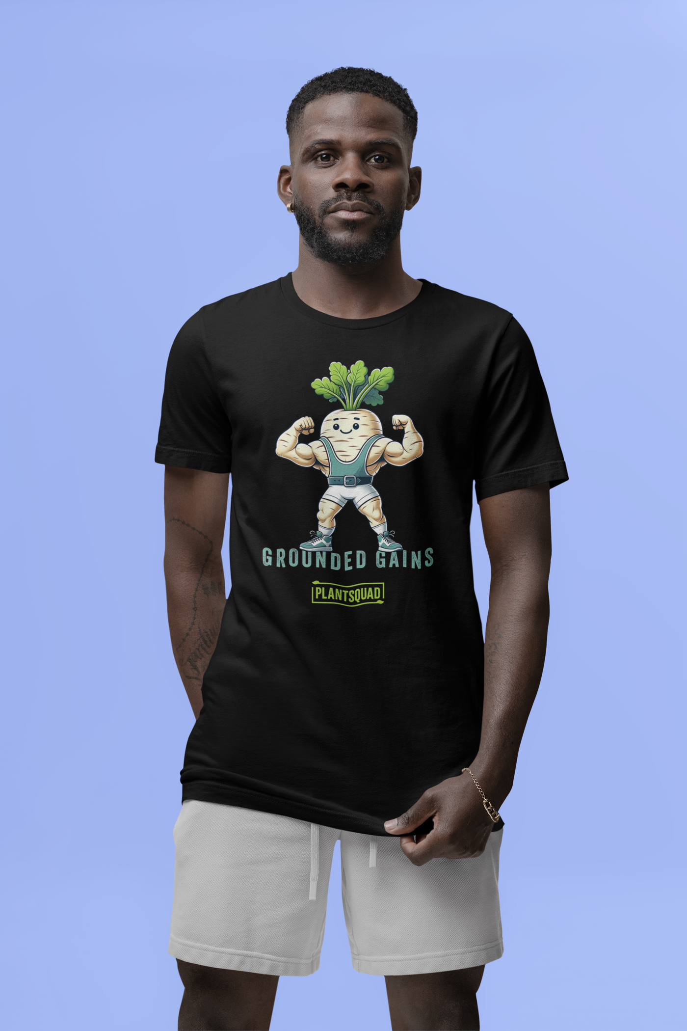 A black vegan T-shirt featuring an illustration of a muscular radish character flexing its arms. Above the character are the words "Grounded Gains," and below is a green box with "Plantsquad" written inside. The design promotes plant-based strength and fitness apparel for a plant-based lifestyle. 

Product Name: Plantsquad Parsnip "Grounded Gains" - Unisex T-Shirt