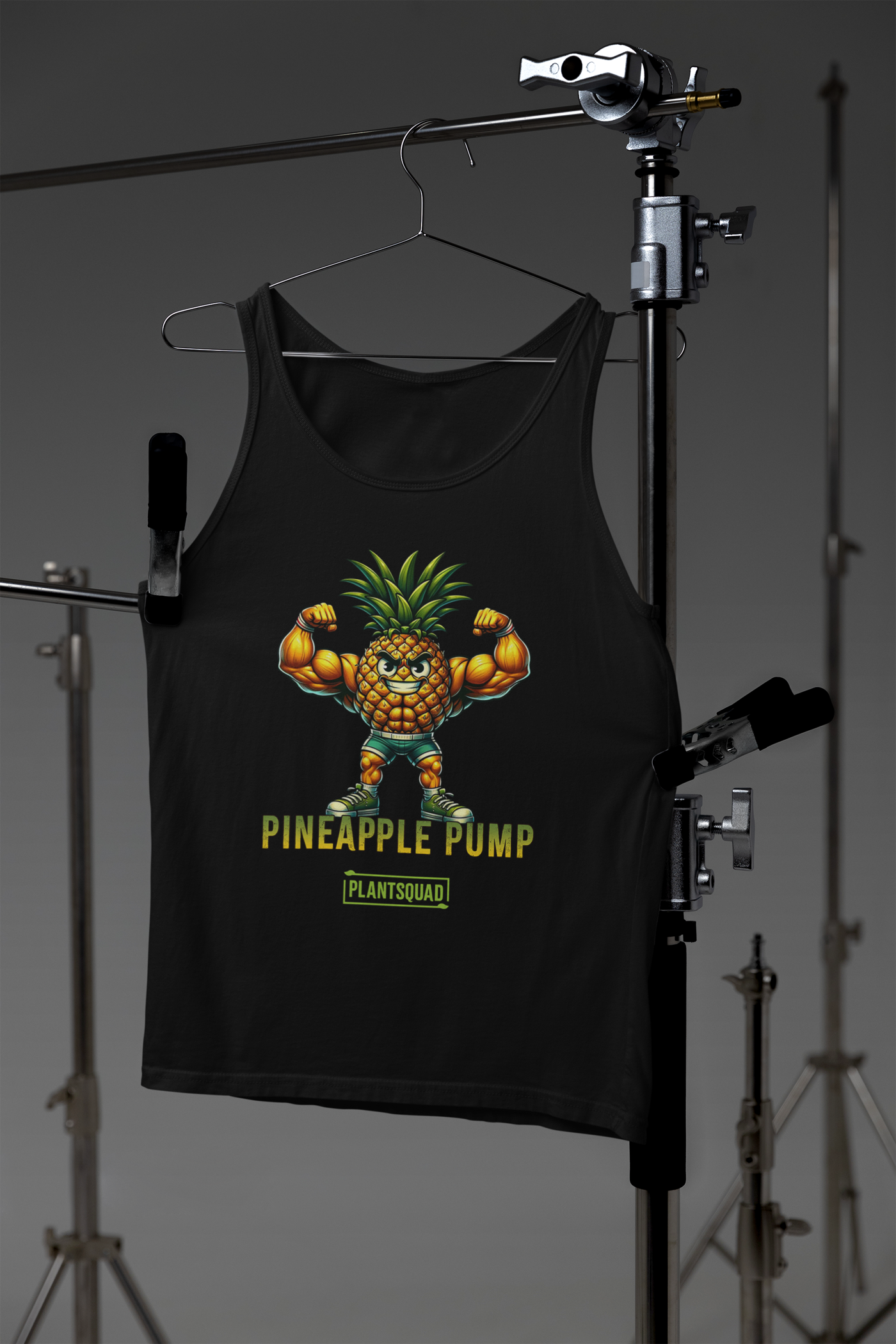 The Plantsquad Pineapple "Pineapple Pump" - Unisex Tank Top showcases a muscular cartoon pineapple flexing its muscles, with the text "Pineapple Pump" and "Plant SQUAD" printed below. Perfect for vegan gym enthusiasts, the smiling pineapple with a green leafy top embodies a plant-based lifestyle.