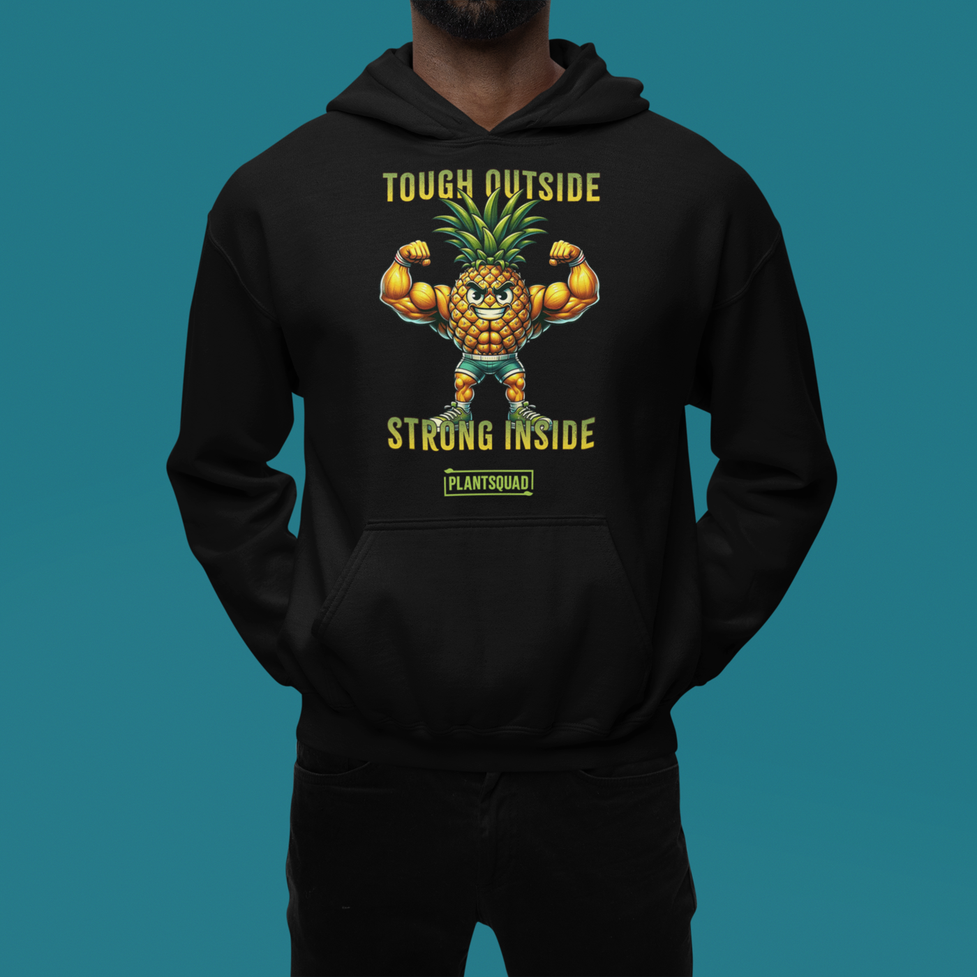 A cozy fabric black Plantsquad Pineapple "Tough Outside Strong Inside" - Unisex Hoodie featuring a muscular pineapple design with green leaves on its head. The pineapple flexes its muscles, with text above reading "Tough Outside," and below, "Strong Inside." Perfect for those embracing a vegan lifestyle, the word "PLANTSQUAD" is also proudly displayed.