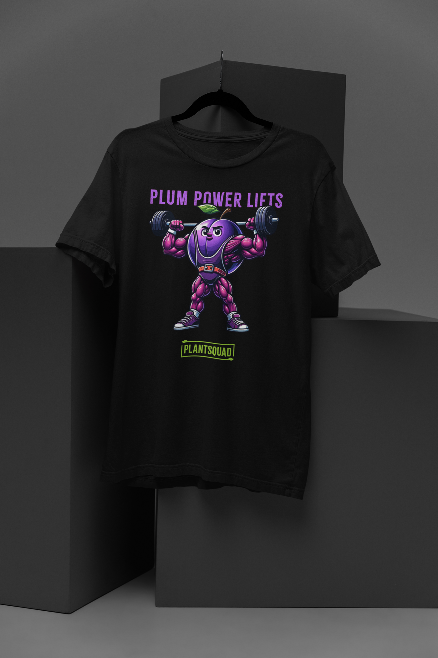 Plantsquad Plum "Plum Power Lifts" - Unisex T-Shirt featuring a cartoon plum with muscular arms and legs lifting a barbell. The text above the image reads "Plum Power Lifts" and below it, there's a logo with "PLANTSQUAD." Perfect for fitness enthusiasts embracing a vegan lifestyle, the plum character is depicted in a vibrant, exaggerated style.