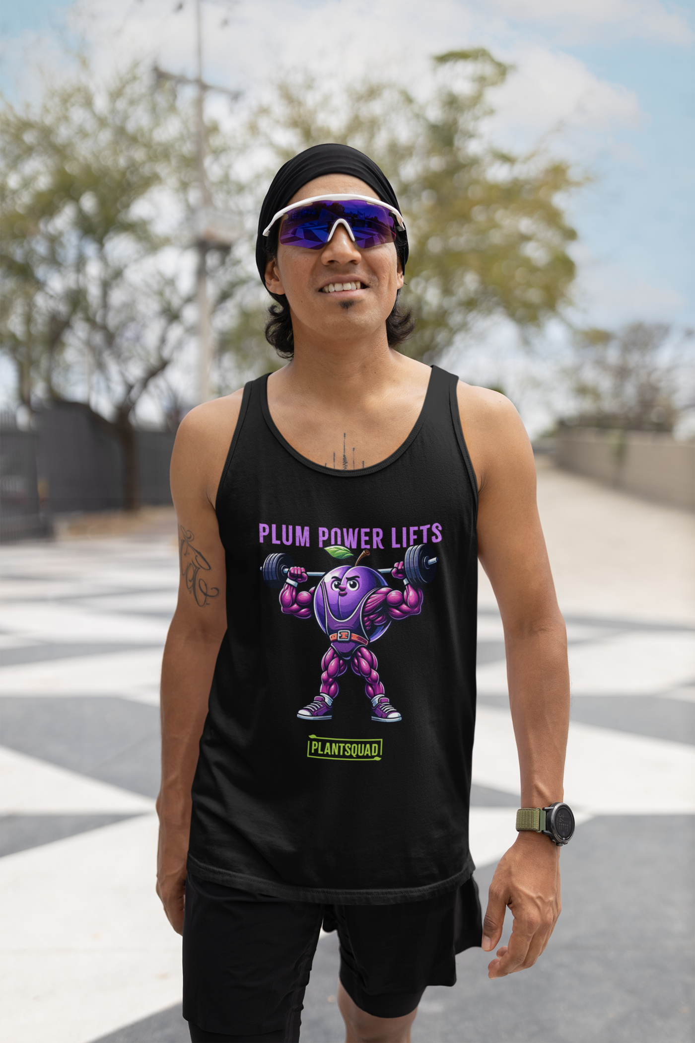 A black Plantsquad Plum "Plum Power Lifts" - Unisex Tank Top featuring a muscular cartoon plum lifting barbells. The text "PLUM POWER LIFTS" is displayed above the plum, and "PLANTSQUAD" is written at the bottom in green and white. Perfect for gym enthusiasts embracing a vegan lifestyle.