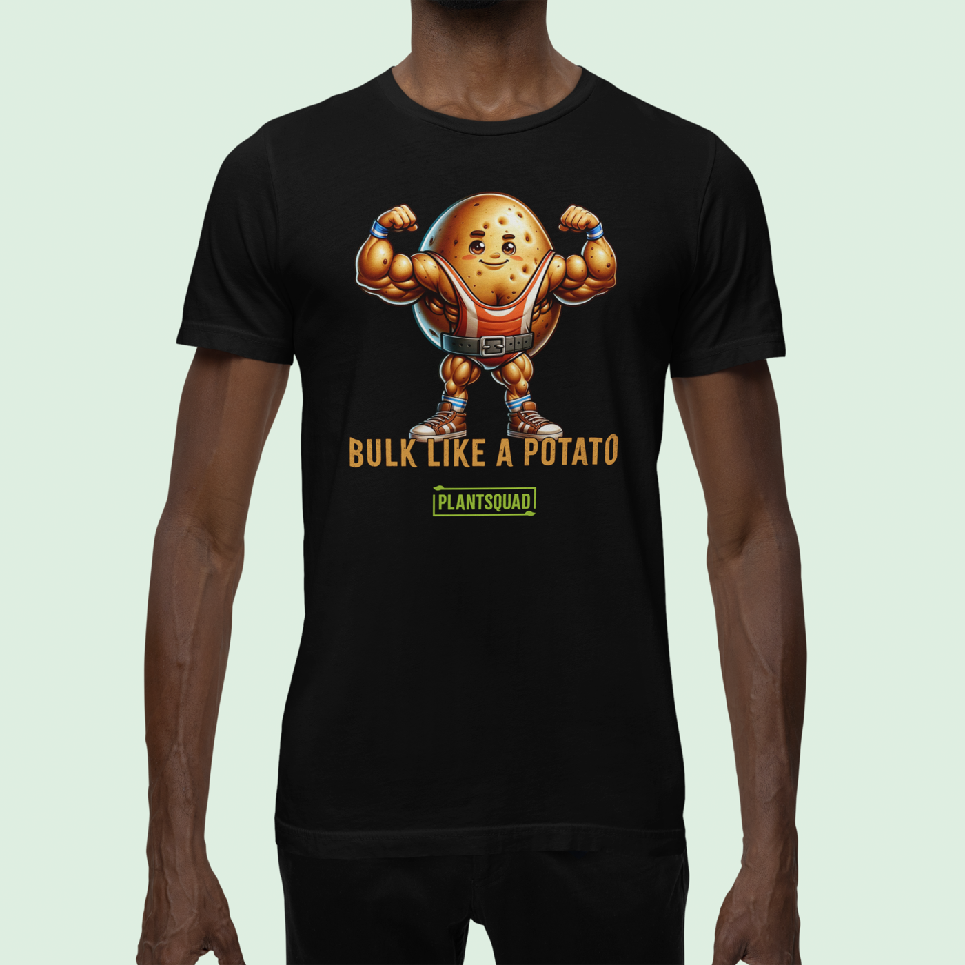 A black Plantsquad Potato "Bulk Like A Potato" - Unisex T-Shirt featuring a cartoon image of a muscular potato flexing its arms with a determined expression. Below the weight-lifting potato, the text reads "BULK LIKE A POTATO" in bold letters. The word "PLANTSQUAD" is also displayed towards the bottom in a green box, promoting a vegan lifestyle.