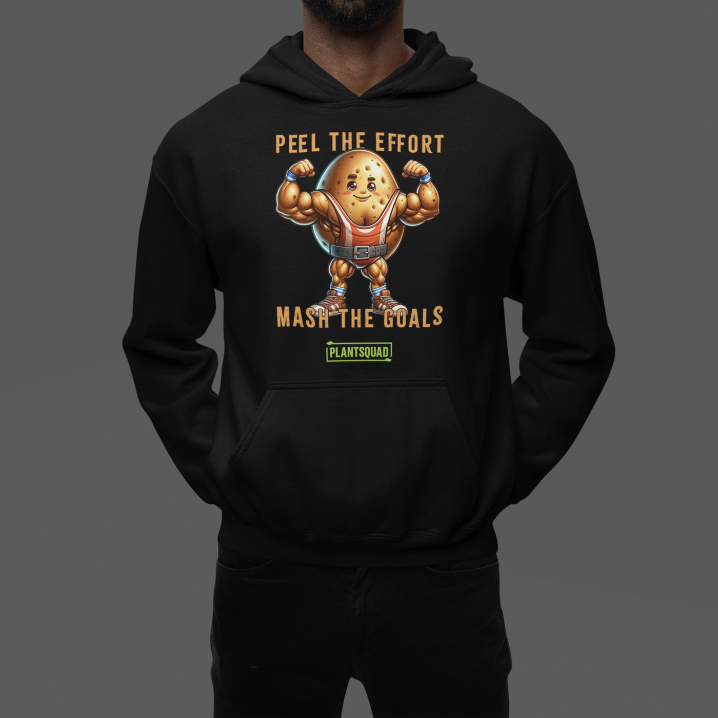 The Plantsquad Potato "Peel The Effort Mash The Goals" - Unisex Hoodie features a muscular potato character lifting weights. Above and below the potato, texts read "Peel The Effort" and "Mash The Goals." Promoting a vegan lifestyle, the word "PlantSquad" is displayed beneath the potato graphic.